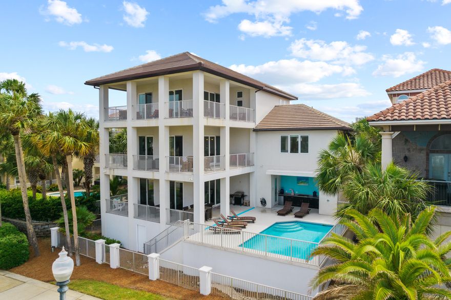 Poised to be a rental MACHINE. Bring offers.Welcome to 8 St Barts Bay. Located in the private community of Destiny East. Boasting over 4,400 sf, large vaulted 10 foot ceilings, and forever GULF VIEWS from all three levels- this home is truly a masterpiece. Perfect for a luxurious primary residence or lucrative investment. On the entry level there is a spacious family room with a fireplace and entertainment area that opens up to the resort style pool deck complete with an outdoor kitchen, surround sound system and shower.