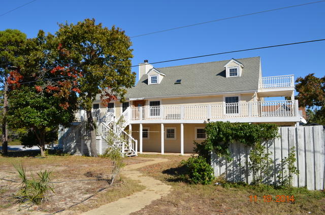 Huge REO home located minutes from the beach and the beach life! The home is just shy of 3000sf and is custom in nearly every respect. All 3 floors have living space with the first floor including a 2 car garage, laundry area and master suite with bath. Up the spiral staircase to the second floor and the living room is massive with a fireplace located in the center of the room. Hardwood floors are found hear and the kitchen is on this floor as well. Another bedroom and full bath as well. Continue to the 3rd floor and another master suite with a large balcony and deck and additional storage and office area. This home has 3 hvac units, water softener systems, 2 water heaters. Home needs some work and will only qualify for conventional financing. Call today for your showing!