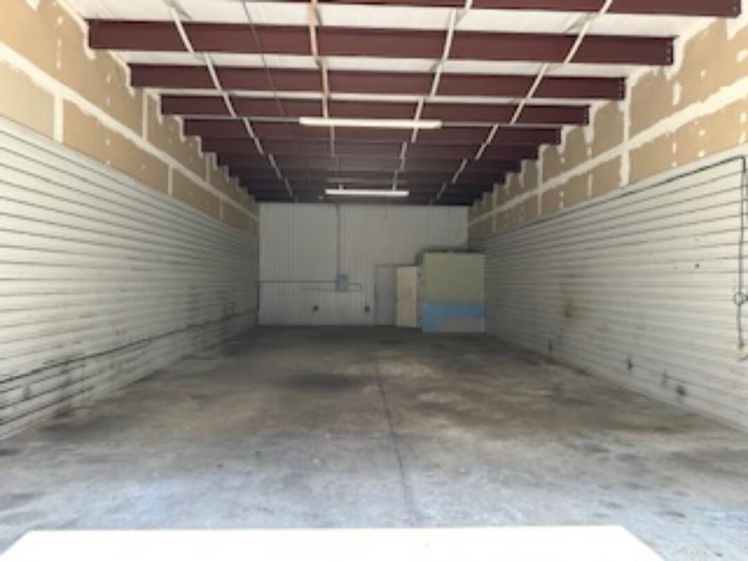 1,500 sq ft 12 x 14 Roll up door large warehouse space with bathroom and 12 x 13 office with ac unit. Storage space above office. two dryer 220 outlets