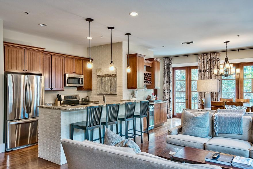 This impressive loft is over the shops in the Village of Baytowne Wharf. Enjoy high ceilings and an open floor plan that shows off the urban style including hard wood flooring through out and brick accent walls. The mahogany french doors wrap around the balcony to overlook Tupelo Courtyard and the retail shops below. Conveys fully furnished and ready to for you and your family.Fishermans Village owners have exclusive access to the lushly landscaped amenities terrace featuring a resort style pool, hot tub, fitness center, lawn, and lovely grilling area as well as to the the Founders Club, featuring a game room with pool table and bar and a balcony overlooking the events plaza.