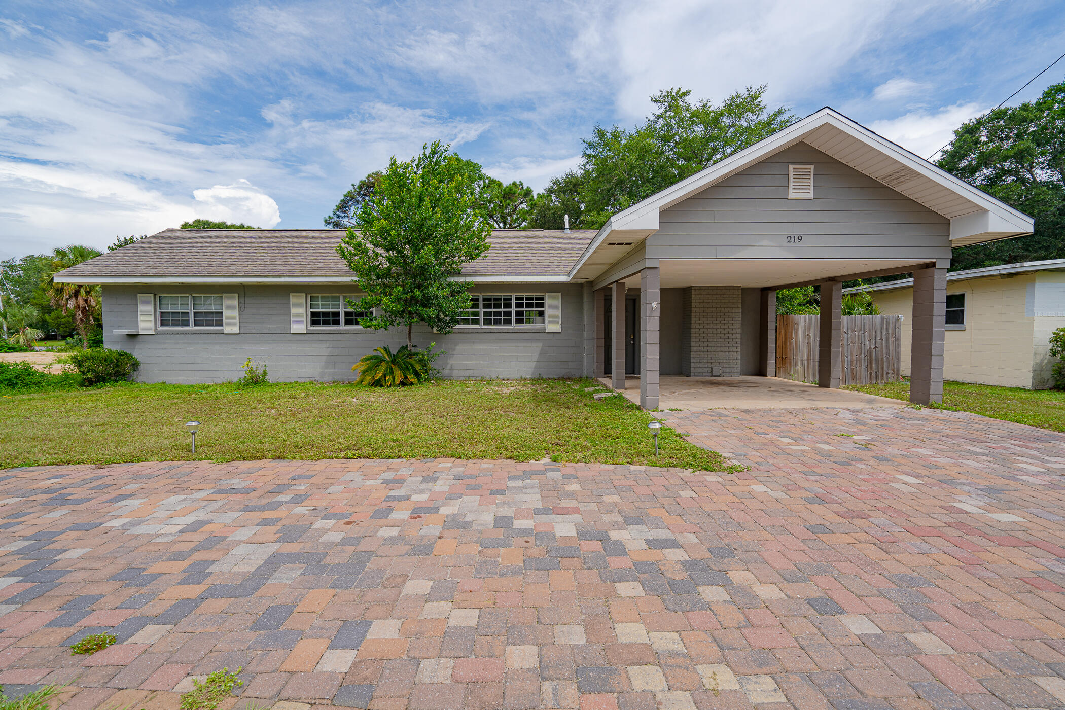 Located directly on Ferry Park, this home was renovated to be a 'Forever Home' in 2018. This cinderblock and brick built home is nestled in a great location in east Fort Walton Beach, and only 10 minutes away from the beautiful beaches of Destin and Okaloosa Island. As you enter the home you'll notice the vaulted ceiling's make the living room spacious and cozy for family gatherings. Tile flooring throughout makes it easy to keep the floors clean and well-maintained. The master suite offers plenty of bedroom space along with a walk-in closet and spacious bathroom with a double vanity. The updated kitchen features a large island as well as stainless steel appliances including a gas stove and counter-depth refrigerator. The quartz countertops, and custom white cabinets give the kitchen a bright and modern feel. Windows above the kitchen sink offer gorgeous views of Ferry Park. The tankless water heater (2018) located in the large pantry is an excellent feature that assures you never run out of hot water. The kitchen opens up to a big backyard that features a covered patio, perfect for entertaining or a relaxing drink after a walk in the park. The patio includes a ceiling fan and is wired to accommodate cable TV. The backyard offers a spacious storage shed and fence that opens directly to Ferry Park. The three guest bedrooms offer plenty of room for children, family members, or office space, and the built-in storage in each room adds to the overall character of the home. The HVAC and duct work were replaced in 2017 and the roof was put on in 2018. Perfectly situated near "Uptown Station", this location offers easy access to restaurants, shopping, gyms, and entertainment.