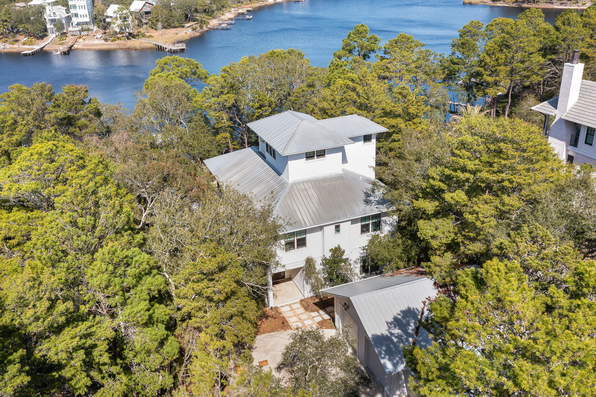 Under contract, accepting back ups. This lakefront home on the coastal dune lake of Camp Creek Lake is nestled among nature on one of 30A's rare and special streets, along the desirable east end of 30A. Designed by the prominent local architect Walt Chancey with Chancey Design, this special lake retreat boasts an idyllic setting with breathtaking views of Camp Creek Lake.  The unique location gives you a peaceful sanctuary among the trees, while being just a mile from Alys Beach. The bustling liveliness of 30A's surrounding popular planned communities are all in close proximity, giving the enjoyment of dining, shopping and events all within a short bike ride from your quiet haven. Characteristic of the rare coastal dune lakes is the outfall connection of the lake directly with the Gulf.