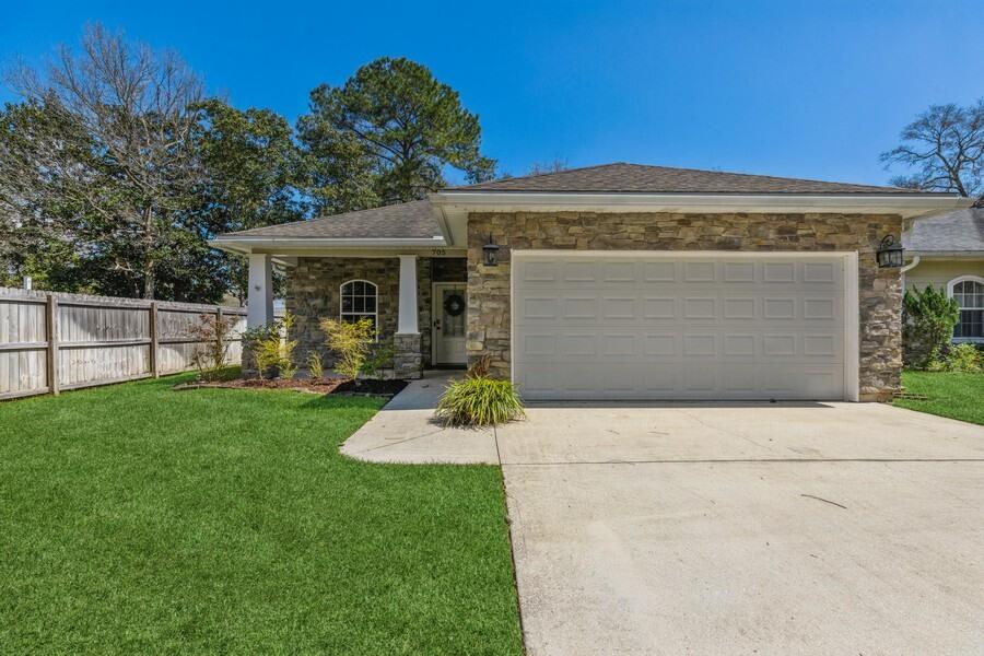 Charming 3 bedroom + a bonus room home in Niceville with gorgeous accented exterior. Privatly Situated at the end of a cul de sac. You enter into an oversized foyer. To the left you have a formal dining room that flows into the grand kitchen with a large island! The kitchen is open to the living area. The living space is spacious with gorgeous tray ceilings. The main bedroom has a large en suite that is oversized and so welcoming! The en suite has a double vanity, jetted tub, large walk in closet, and separate shower! The built-in kitchen exterior is inviting and perfect for entertaining. It comes equipped with a gas grill, a refrigerator, and a custom stone patio. Additional features include: pre-wired for surround sound, two car garage, and legacy cabinets.