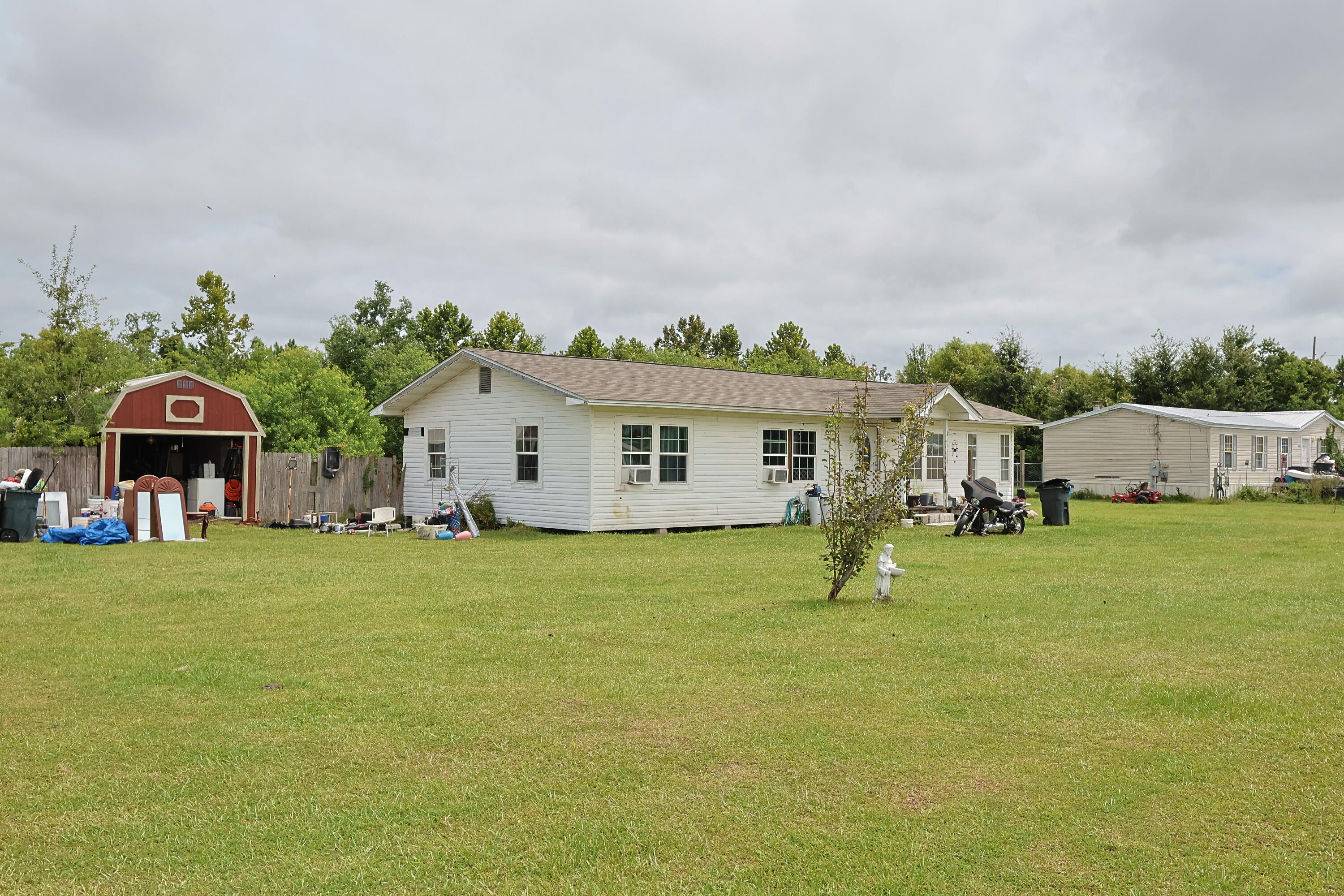 Located just minutes from Tyndall Air Force Base and a short drive to Panama City, this 3-bedroom, 1-bath home offers approximately 1,350 sq. ft. of living space on a spacious lot just under an acre. Seller will not make any repairs and is selling AS-IS. The property requires significant cleanup and repairs but is priced well below comparable homes in the area to reflect its condition. This is a great opportunity for investors or those looking for a renovation project with strong potential. The generous lot provides plenty of room for outdoor storage, parking, or future improvements. Buyer to verify all pertinent information, including measurements and zoning. Shed does not convey. Call to schedule you showing.