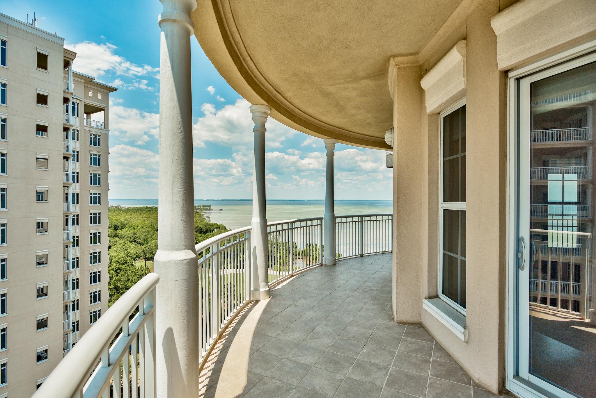 Experience the privacy and luxury of One Water Place, Kelly Plantation's crown jewel, with countless first-rate amenities and panoramic views of the Gulf of Mexico and the Choctawhatchee Bay. Park in one of your two deeded underground spaces and take the private elevator to the foyer of your 12th-floor residence, the Castleton floor plan, which features three bedrooms plus a bonus room that could become an office, a fourth bedroom, or a second living area. Upon entering the front door, you're immediately greeted by a southward view of the beautiful Gulf of Mexico through the windows of the bonus room. Turn right to walk down the hallway to the main living areas showcasing a dramatic fireplace, floor-to-ceiling windows, and a wrap-around terrace on three sides.