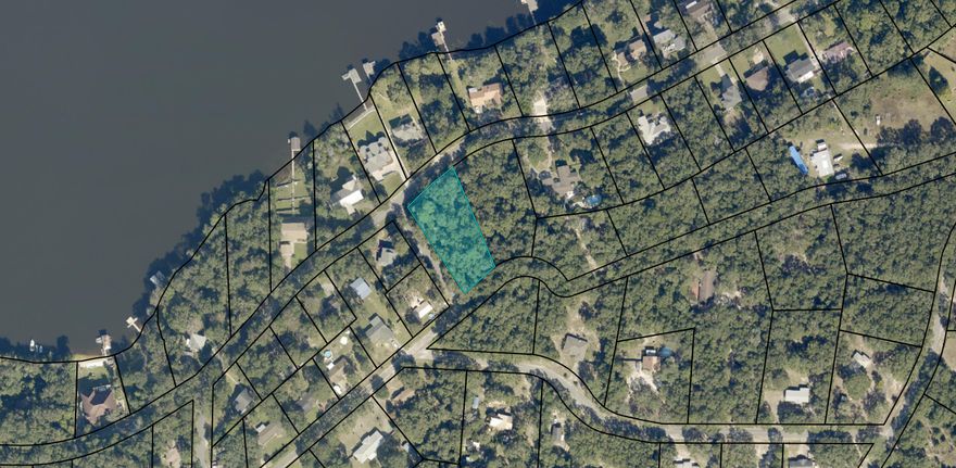 Almost an acre ~ with view of Wright's Basin. Lot sits on the high side of Lakeside Drive so you should be able to build with a view from all front rooms and possibly a large wrap around front porch! Land is corner lot (Cynthia and Lakeside) and is wonderfully placed with slight slope and is covered with lovely oaks and magnolias. Unusually perfect for you dream home and might even be suitable for a basement! Plenty of room for rear/side entry shop, a garden or an inground pool - maybe even have all 3! There are boat launches and public beaches nearby at lovely Marquis Basin and Harbour Park plus this location is convenient to I-10 access at Ward Basin Road! East Milton Water. Gulf Power for electricity; Gas thru City of Milton; city Suer and water.