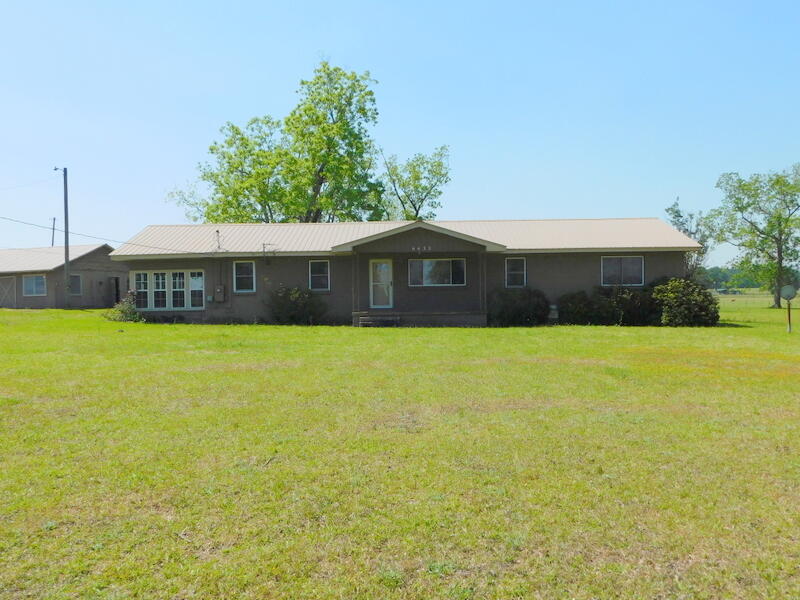 A wonderful country setting on 4 acres of plush lawn and very mature Pecan trees. This one owner home is located about 8 miles east of Jay Fl. at the Berrydale crossing. There are large well manicured farms surrounding this property providing awesome views, sunrises and sunsets. Only 20 minutes north of Milton and a short drive to Pensacola or Crestview. There is a metal roof, a 32x26 barn/workshop with concrete floor and power. Inside you find an updated kitchen with Oak cabinetry, tiled floors and nice appliances. There are wood laminated floors in living areas. A separate laundry / mudroom and outside access. This One-Owner home is being sold through an estate and must go through the courts once and offer is accepted. This will take about 45-60 days. Sold AS IS -CASH offers only