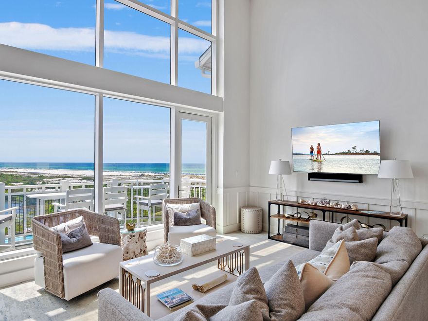 This gulf-facing condo in WaterSound Beach tears up the rule book when it comes to conservative architecture. From soaring windows framing gulf and lake views to a bonus living space in the mezzanine loft, this luxury retreat is all about the view. Sitting high above the dune lakes, this residence has a light, bright living space with 20-ft. ceilings and stunning two-story-high windows framing incredible coastal views from the sitting area, dining room and the newly revamped kitchen. If you want to feel the breeze, just step outside onto the balcony and breathe in the fresh sea air. Fully renovated to the highest standard, it has new custom lighting and fresh paint, creating a cool coastal feel. Three new HVAC units ensure comfort and efficiency. There's a guest bedroom on the main floor, along with a newly updated bathroom, which has a tiled shower. The stunning chef's kitchen showcases new cabinetry topped with gorgeous quartz countertops. High-end appliances include a Viking refrigerator, range, and Bosch dishwasher, minimizing time spent on kitchen duty. A cool bar offers a perfect space to hang out over a glass of wine while making plans for the evening. It supplements the spacious dining table, which seats an additional six diners. Ascend a flight of stairs to the mezzanine level, which is furnished with a sleeper sofa and TV. It's the perfect bonus space for watching TV or accommodating additional overnight guests. The half-height rail offers expansive open views of the sitting room below and the stunning coastal views. Hardwood stairs also lead down to the lower floor, where there's a guest bedroom with a beautifully updated bathroom featuring a walk-in shower. Beyond the laundry room, the tastefully appointed primary suite is a peaceful retreat with its own sitting area. The adjoining bathroom has been completely re-imagined to include a seated vanity, a fully tiled walk-in shower and a freestanding oval tub. This oversize master suite also has its own private balcony, providing the perfect hideaway for reading or sipping coffee before the day begins. With a proven rental history, this fully furnished property is ready to enjoy as a smart investment property, a vacation retreat, or your full-time coastal home. This outstanding Compass Point II residence includes a detached garage for storing golf carts, beach chairs and bicycles. WaterSound residents and guests have access to a host of enviable amenities, including golf, community pools, tennis and pickleball courts, a wellness center, dining, boutique shopping, and a private beach.

