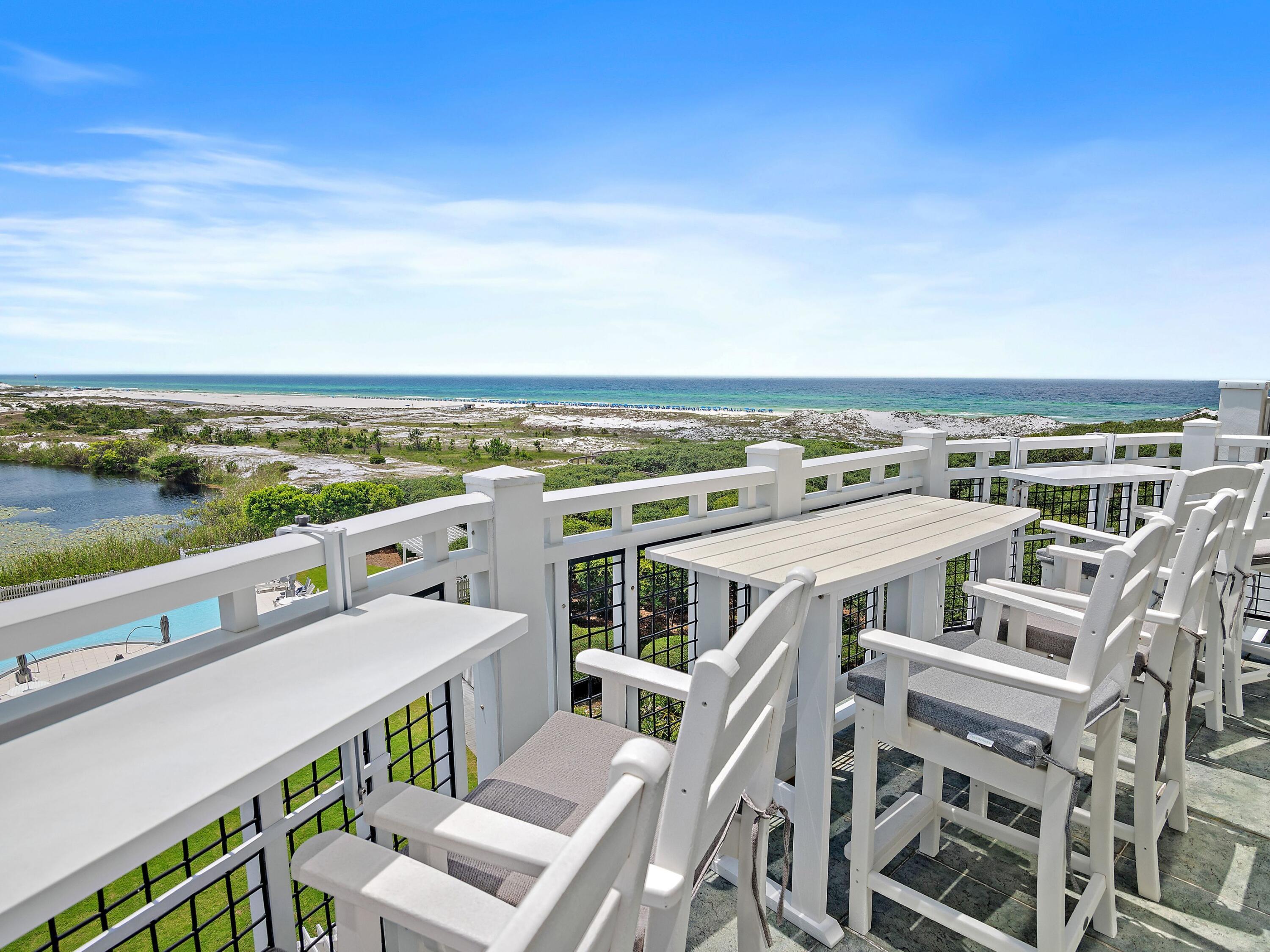 This gulf-facing condo in WaterSound Beach tears up the rule book when it comes to conservative architecture. From soaring windows framing gulf and lake views to a bonus living space in the mezzanine loft, this luxury retreat is all about the view. Sitting high above the dune lakes, this residence has a light, bright living space with 20-ft. ceilings and stunning two-story-high windows framing incredible coastal views from the sitting area, dining room and the newly revamped kitchen. If you want to feel the breeze, just step outside onto the balcony and breathe in the fresh sea air. Fully renovated to the highest standard, it has new custom lighting and fresh paint, creating a cool coastal feel. Three new HVAC units ensure comfort and efficiency. There's a guest bedroom on the main floor, along with a newly updated bathroom, which has a tiled shower. The stunning chef's kitchen showcases new cabinetry topped with gorgeous quartz countertops. High-end appliances include a Viking refrigerator, range, and Bosch dishwasher, minimizing time spent on kitchen duty. A cool bar offers a perfect space to hang out over a glass of wine while making plans for the evening. It supplements the spacious dining table, which seats an additional six diners. Ascend a flight of stairs to the mezzanine level, which is furnished with a sleeper sofa and TV. It's the perfect bonus space for watching TV or accommodating additional overnight guests. The half-height rail offers expansive open views of the sitting room below and the stunning coastal views. Hardwood stairs also lead down to the lower floor, where there's a guest bedroom with a beautifully updated bathroom featuring a walk-in shower. Beyond the laundry room, the tastefully appointed primary suite is a peaceful retreat with its own sitting area. The adjoining bathroom has been completely re-imagined to include a seated vanity, a fully tiled walk-in shower and a freestanding oval tub. This oversize master suite also has its own private balcony, providing the perfect hideaway for reading or sipping coffee before the day begins. With a proven rental history, this fully furnished property is ready to enjoy as a smart investment property, a vacation retreat, or your full-time coastal home. This outstanding Compass Point II residence includes a detached garage for storing golf carts, beach chairs and bicycles. WaterSound residents and guests have access to a host of enviable amenities, including golf, community pools, tennis and pickleball courts, a wellness center, dining, boutique shopping, and a private beach.