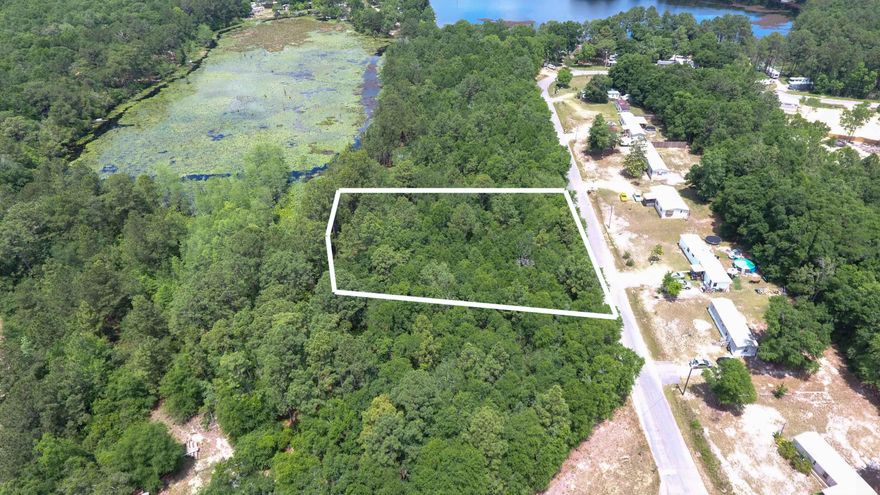 Fantastic opportunity on Juniper Lake. This lot is perfect for a manufactured home, a new build, or even a secluded fish camp. The property will require some clearing and offers endless possibilities. The location is truly ideal, just 5 minutes to downtown historic DeFuniak Springs, providing both convenience and tranquility. Whether you're looking to create a permanent residence or a weekend getaway, this lot has the potential to bring your vision to life!