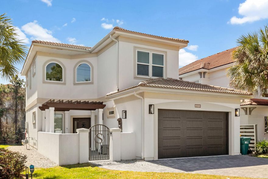 This stunning 4-bedroom Mediterranean-style residence, built in 2021, is a seamless blend of luxury, comfort, and modern elegance. Nestled within a gated lakefront community just minutes from Destin's premier beaches, shopping, and dining, the home features polished concrete floors on the main level, durable LVP upstairs, and a chef's kitchen outfitted with custom cabinetry, quartz and granite countertops, and premium appliances. The light-filled open layout flows effortlessly into a private courtyard and expansive waterfront sun deck - perfect for relaxed outdoor living and entertaining. Upstairs, a versatile second living area offers the perfect space for a media room, home office, or cozy retreat. Dual laundry rooms including one tucked inside the primary suite's walk-in closet add exceptional functionality. Built with durability in mind, the home features Zip System sheathing, hard coat stucco, and is pre-plumbed for a generator. A two-zone HVAC system ensures optimal comfort throughout the seasons, while a spacious two-car garage offers ample storage. Designed with enduring materials and refined finishes, this Calusa Bay residence pairs resilience with style, creating a serene and sophisticated lakefront sanctuary. 
