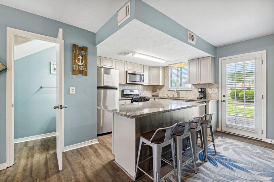 Welcome! This delightful property offers a fantastic opportunity to own a beautiful home in a highly sought-after community. Nestled in a prime location backing out to one of the 11 community pools and tennis courts, this attractive unit has been updated with all new LVP flooring throughout, hardwood stairs, granite countertops, solid wood cabinets, fresh paint, SS appliances, furniture, accessories and more. New roof in 2023. 2 spacious bedrooms upstairs and an updated full bath. STR allowed with amazing projected ROI & rental history! VA & FHA approved. 2 assigned parking spots in front of the unit. The outdoor living spaces are equally impressive. Step out onto the spacious patio and take in the warm Florida sunshine or enjoy a refreshing drink while overl