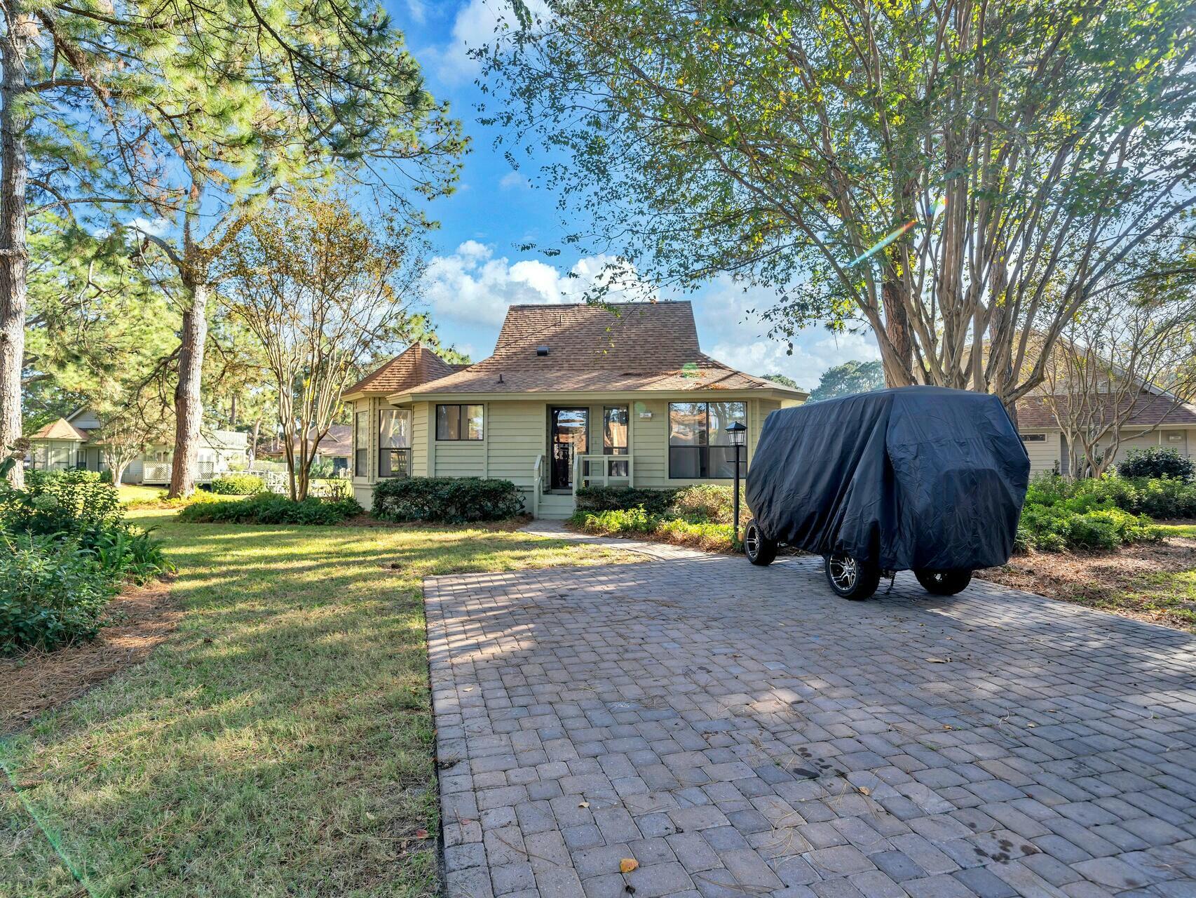 Enjoy the lake views while you enjoy your morning coffee or afternoon refreshment on the screened porch.  This cottage has been TOTALLY remodeled. It has been painted throughout, has new LVP flooring, new kitchen cabinets, and quartz on the countertops. All of the appliances are new including the washer and dryer.  Both bathrooms have been beautifully remodeled. There is crown molding throughout the home. The roof was replaced in 2022 and the exterior of the home was painted in 2023. A new water heater was installed in 2021. The HVAC is 2016 but all ducts were cleaned in 2024. The beautiful furnishings were just purchased and make for a relaxing, comfortable setting. It is move in ready for your family to enjoy on beach vacations or can be used as a short term rental. The new community pool which should be completed by spring is just steps away.  The golf cart does not convey and neither does the computer system.