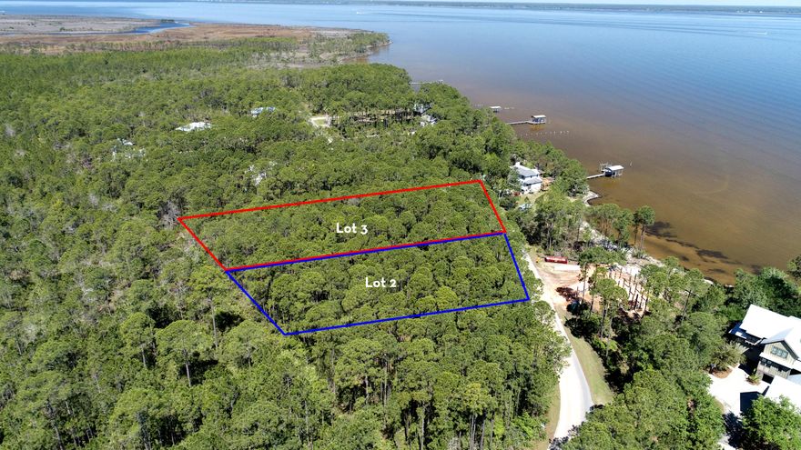 This stunning, large (.75 acre), wooded lot sits directly across from Whispering Pine neighborhood bay front park shown in its original County recorded plat map. It's like owning bayfront without worrying about any sea wall construction on the shore or waterfront erosion later during ownership. Lot 2B, adjacent to Lot 3B, is also available. Own two large lots -- each lot is over 1/2 acre -- and both have dedicated and outstanding bayviews. Additional value includs, paid water & sewer tap fees. Outstanding opportunity for a builder/owner. Call Bobby J to learn more about the values of owning two lots side by side. These two lots are contiguous so a future homeowner can homestead both lots combined together to form over an acre and a quarter of a large bayside estate..