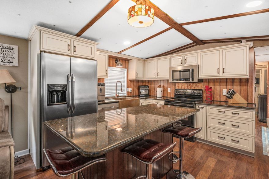 UNDER CONTRACT WITH A 72 HOUR KICK-OUT CLAUSE. Nestled on 11.5 acres, this 2-bedroom, 2-bathroom home makes the most of every space. A thoughtfully designed addition created a spacious master suite with a private bathroom and its own secluded porch. Enjoy expansive porches on both the front and back of the home, perfect for relaxing and taking in the peaceful surroundings.Outside, a tiny home with a half bath and kitchenette  provides the perfect private space for weekend guests. Additional features include an enclosed shed, a carport, and a 20' x 30' powered workshop--ideal for hobbies, storage, or projects. The mostly wooded acreage is home to a beautiful spring-fed creek at the back corner. Recent updates include a new well in 2025 and a septic pump in 2023.