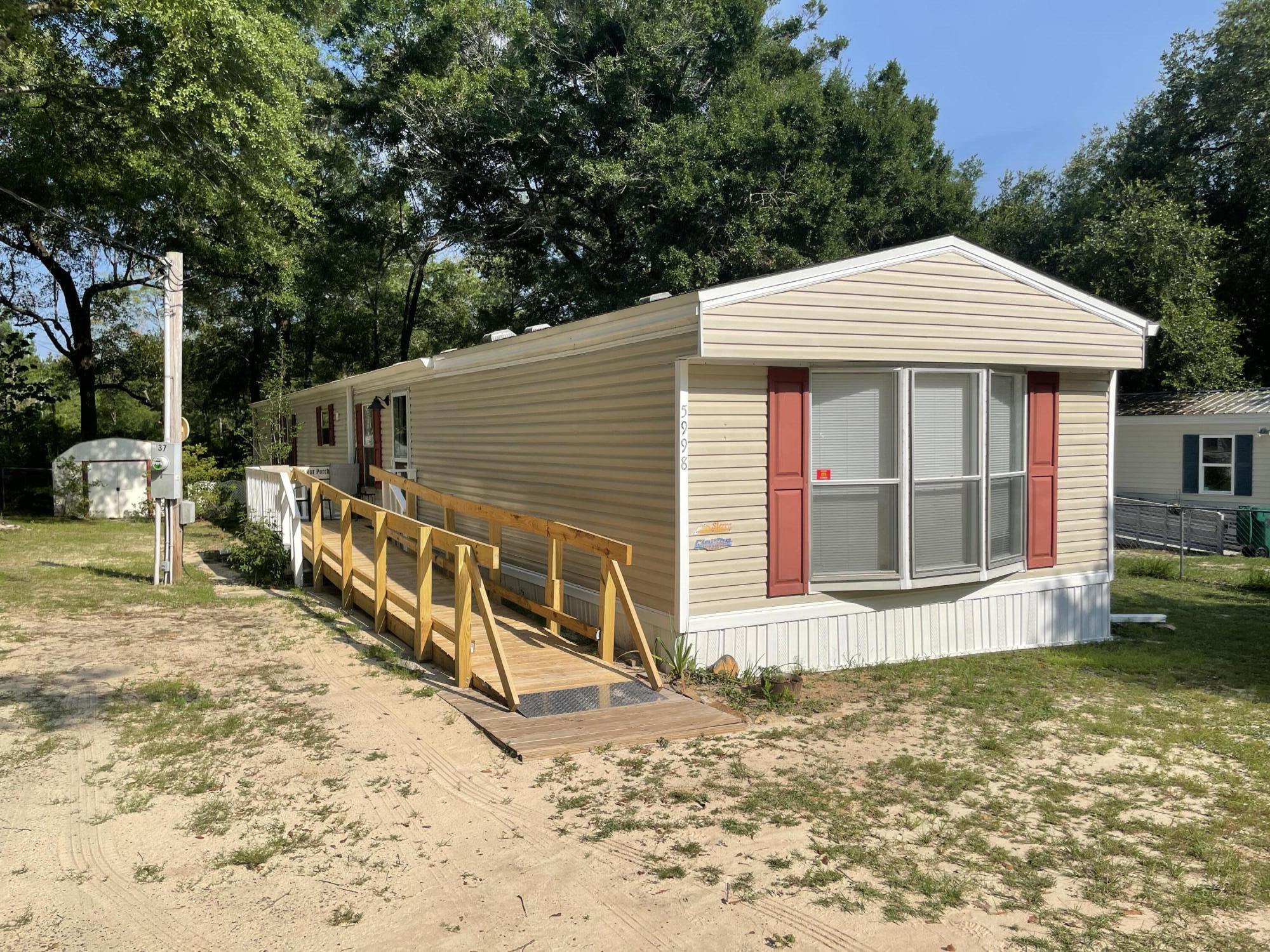**Multiple offers - Seller has requested all highest and best offers to be submitted along with proof of funds by Friday July 19th at 5:00. **Spacious one-owner home less than five minutes from Winn Dixie and Publix in a quiet mobile home park. Clean and well maintained. The owner always takes her shoes off at the door. Carpet in living room and bedrooms. Ceramic tile in all wet areas. Large, lighted closets. Master has two walk-ins. Solid wood cabinetry. Electric fireplace for ambiance. HVAC replaced in 2012. New shingle roof in 2013. Water heater replaced in 2014. Stove replaced in 2019. Refrigerator, dishwasher and microwave all replaced in 2022. Plantation shutters in dining area and 2-inch faux wood blinds elsewhere. Rain gutters with leaf guards. Electrified shed on a slab with its own front porch, plus a metal shed for garden tools. Hose bibs mounted on solid posts. Covered back porch. Purchase does not include the lot, just the home and sheds. Lot rent is $450 per month.