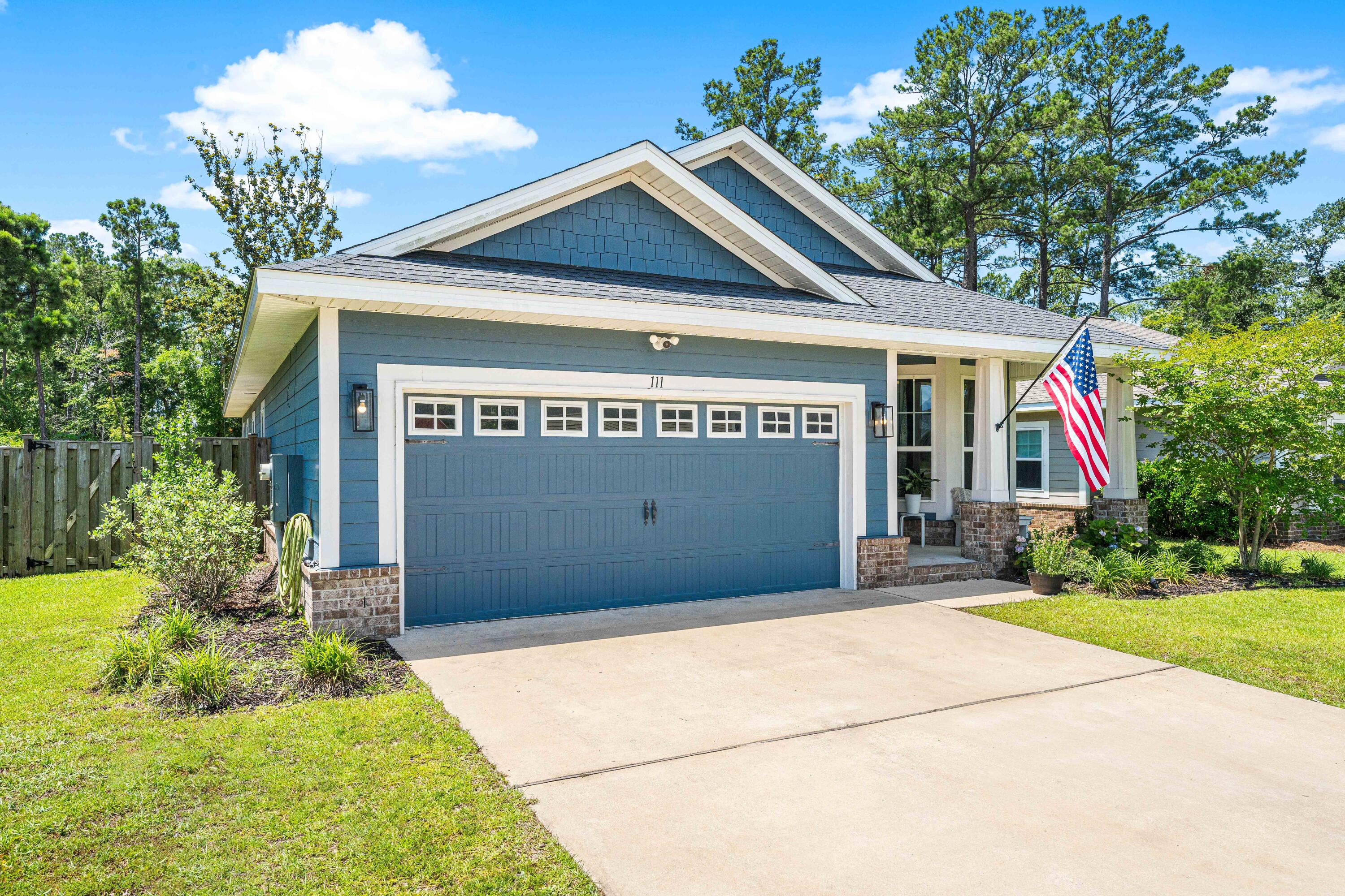 Welcome to this beautiful three-bedroom, two-bath craftsman-style home in the gated community of Lafayette Creek Landing. This peaceful neighborhood offers access to a community pool, fitness center, and scenic walking trails, all just minutes from a Publix supermarket and less than a 20-minute drive to white sand beaches. The home features elegant upgrades throughout, including a striking fireplace that serves as a focal point in the living area. The stylish kitchen offers a modern backsplash, granite countertops, stainless-steel appliances, and ample cabinet space. Durable LVP flooring and shiplap accents in the living room add warmth and character. The spacious primary suite provides comfort and privacy, while the open-concept layout leads to an ample patio and fully fenced backyard. As you enter the home, a spacious dining area is adjacent to the kitchen, providing an effortless flow between the two. Stainless steel appliances, a beautiful white backsplash, and granite countertops accentuate the modern kitchen. There is an abundance of cabinet and pantry space for easy storage. The kitchen opens to the breakfast bar and living room, which is centered around a charming wood-burning fireplace. From the living room, you will find easy access to the spacious patio, perfect for an outdoor dining table and enclosed by a backyard fence.
The commodious primary bedroom is located at the back of the home, offering privacy and comfort. A large primary walk-in closet provides plenty of personal storage. Two additional bedrooms share a full bathroom and lie just down the hall from the primary bedroom. At the end of the hall, the laundry room houses shelves and offers access to the two-car garage.
The front porch offers space for a bench, perfect for enjoying views of the lush landscaping and well-maintained flower beds. A fenced backyard provides a generous and welcoming area for relaxation and play.
Experience the charm and convenience of living in Freeport, a vibrant community known for its friendly atmosphere and access to coastal lifestyle amenities. With close proximity to beautiful beaches, shopping, dining, and recreational options, Freeport offers the perfect blend of small-town comfort and modern convenience. Whether you're seeking a permanent residence or a vacation retreat, this location provides easy access to everything that makes Emerald Coast living so desirable.