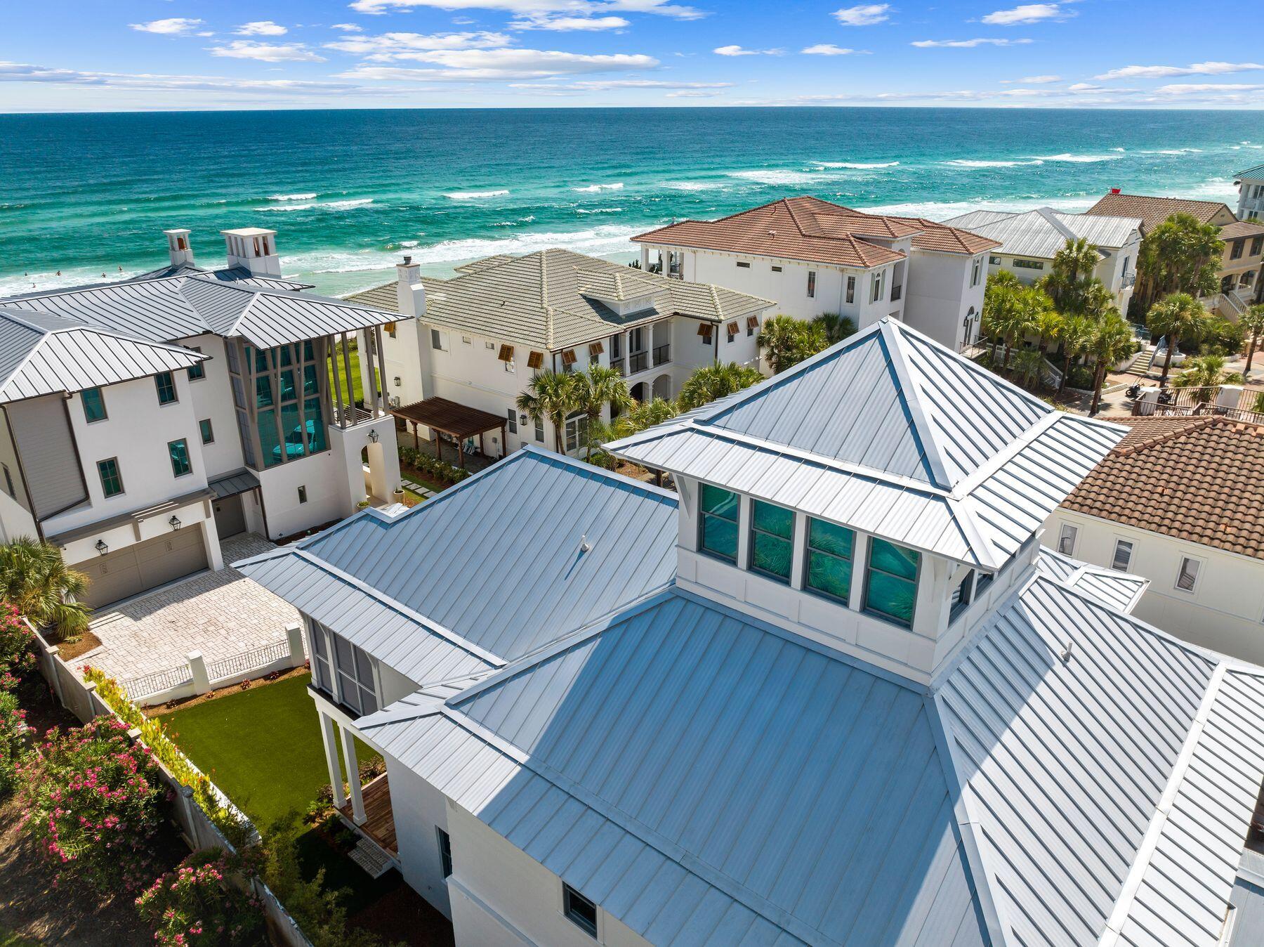 Under contract with a 72 hr kick-out clause. Welcome to this meticulously crafted coastal-contemporary retreat nestled in The Village of White Cliffs along Scenic Highway 30A. Designed by renowned architect Chris Stoyles of Archiscapes and built by Grand Bay Construction in 2023, this luxurious four-bedroom home is situated just steps away from the Gulf of Mexico, boasting an array of modern amenities and breathtaking second-row views. Upon entering, you are greeted by spacious interiors featuring 12-foot ceilings, engineered hardwood floors with a custom finish, and Sierra Pacific FeelSafe Double Hung Windows that are tinted for privacy and safe for local wildlife. The expansive guest bedrooms, each complete with en-suite bathrooms and walk-in closets, offer unparalleled comfort and privacy. The first level offers an oversized one-car garage with custom storage solutions, a spacious laundry room and a private elevator. Located on the second-level, the primary suite offers comfort and privacy with a spacious en-suite bathroom with dual vanities, a soaking tub and large walk-in shower. The heart of the home is the chef's kitchen, equipped with KitchenAid commercial appliances, a wine fridge, drawer microwave and quartz countertops throughout. A custom wall pantry with soft-close shelves complements the sleek design, ideal for culinary enthusiasts. The expansive kitchen seamlessly flows into the dining and living areas opening up to the wraparound deck with impressive views of the gulf. Additionally, a third-level offers a flex space for use as an office, crafting space, or exercise room along with unfinished storage areas. For relaxation and entertainment, the home features a conditioned cupola providing 180-degree views of the Gulf, a perfect setting for enjoying sunsets. Outdoor living is enhanced by wrap-around Cumaru wood decks with ceiling fans and custom horizontal railings, creating inviting spaces to enjoy the coastal climate. A large artificial turf front yard and a seven-person hot tub complete the outdoor experience. Residents of The Village of White Cliffs enjoy a rental-restricted environment with a gated entry and access to exclusive amenities including a private beach, clubhouse with a full kitchen, lounge area, billiards room, fitness center, tennis and pickleball court, and a community pool. This coastal sanctuary offers the ultimate blend of luxury, tranquility and community, making it a rare find along Scenic Highway 30A.