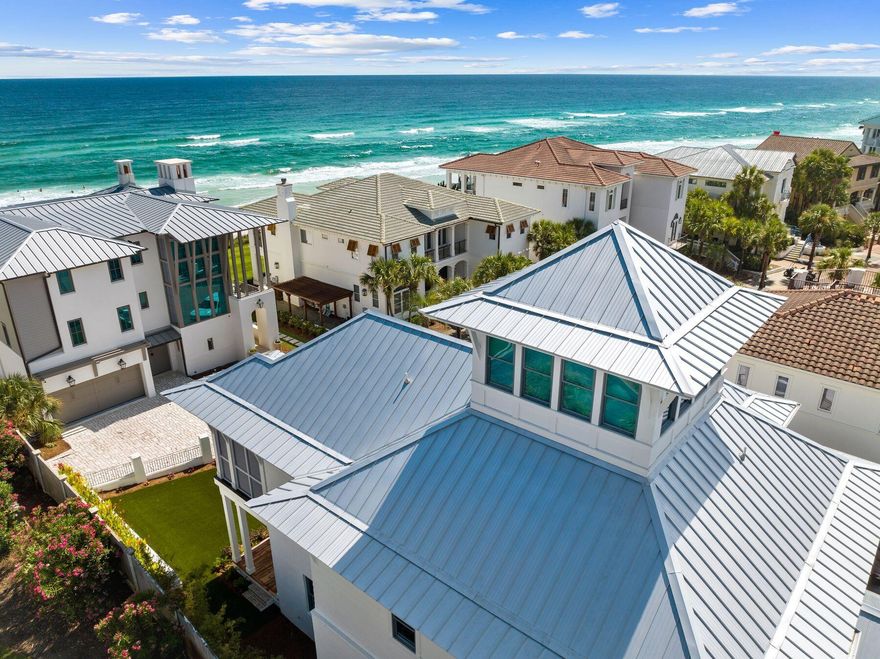 Under contract with a 72 hr kick-out clause. Welcome to this meticulously crafted coastal-contemporary retreat nestled in The Village of White Cliffs along Scenic Highway 30A. Designed by renowned architect Chris Stoyles of Archiscapes and built by Grand Bay Construction in 2023, this luxurious four-bedroom home is situated just steps away from the Gulf of Mexico, boasting an array of modern amenities and breathtaking second-row views. Upon entering, you are greeted by spacious interiors featuring 12-foot ceilings, engineered hardwood floors with a custom finish, and Sierra Pacific FeelSafe Double Hung Windows that are tinted for privacy and safe for local wildlife. The expansive guest bedrooms, each complete with en-suite bathrooms and walk-in closets, offer unparalleled comfort and privacy. The first level offers an oversized one-car garage with custom storage solutions, a spacious laundry room and a private elevator. Located on the second-level, the primary suite offers comfort and privacy with a spacious en-suite bathroom with dual vanities, a soaking tub and large walk-in shower. The heart of the home is the chef's kitchen, equipped with KitchenAid commercial appliances, a wine fridge, drawer microwave and quartz countertops throughout. A custom wall pantry with soft-close shelves complements the sleek design, ideal for culinary enthusiasts. The expansive kitchen seamlessly flows into the dining and living areas opening up to the wraparound deck with impressive views of the gulf. Additionally, a third-level offers a flex space for use as an office, crafting space, or exercise room along with unfinished storage areas. For relaxation and entertainment, the home features a conditioned cupola providing 180-degree views of the Gulf, a perfect setting for enjoying sunsets. Outdoor living is enhanced by wrap-around Cumaru wood decks with ceiling fans and custom horizontal railings, creating inviting spaces to enjoy the coastal climate. A large artificial turf front yard and a seven-person hot tub complete the outdoor experience. Residents of The Village of White Cliffs enjoy a rental-restricted environment with a gated entry and access to exclusive amenities including a private beach, clubhouse with a full kitchen, lounge area, billiards room, fitness center, tennis and pickleball court, and a community pool. This coastal sanctuary offers the ultimate blend of luxury, tranquility and community, making it a rare find along Scenic Highway 30A.