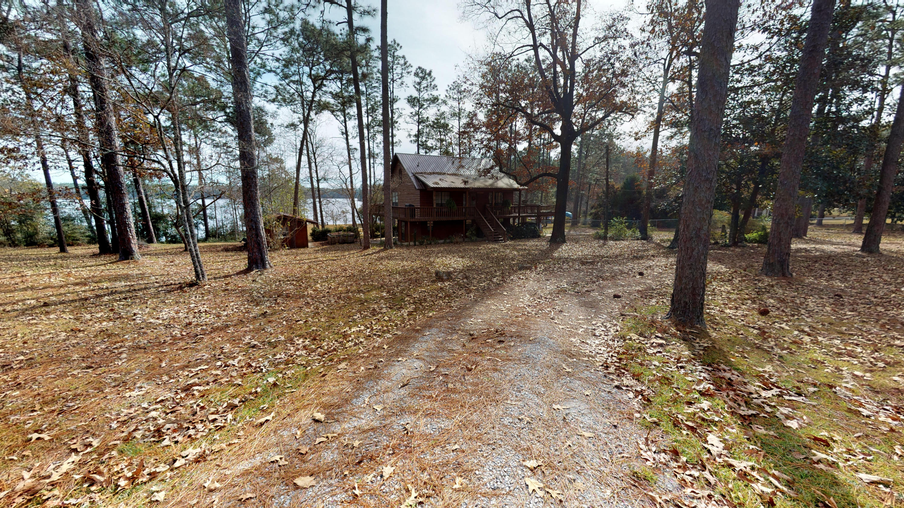 Beautiful log cabin on Spring Lake! This home has incredible views and private access to the lake! Enjoy the sunrises and sunsets on your wrap-around porch! Bottom floor would be great for guests, kids or use as a mother-in-law suite! So many possibilites! 1.95 acre lot with outdoor storage shed with electricity! New metal roof (2018) & Dock boards and bridge have all been replaced (2019)! Don't wait, schedule an appointment today! Be sure to check out the Matterport tour https://my.matterport.com/show/?m=YFzV1egzvmP&mls=1*24 Hour Notice Preferred*