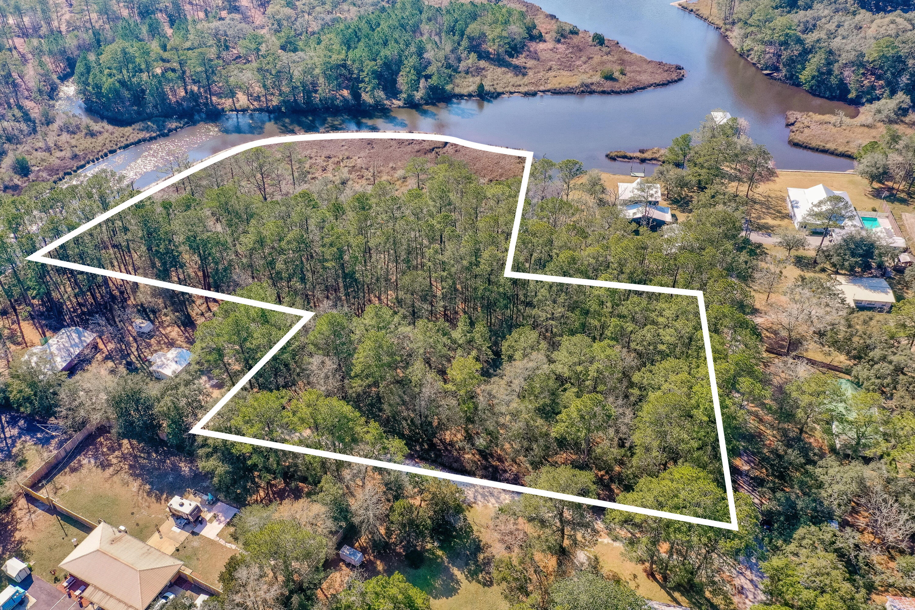 SO MUCH POTENTIAL with this 3.96 acre waterfront parcel on Lowrey Road. The city of Freeport has this property classified as (C2) high intensity commercial, and could be ideal for a live/work property, multifamily/townhomes, manufacturing, marina, RV storage, or a host of other opportunities. Has potential for Zoning change to residential if seeking to build a single family home. Contact the city of Freeport for information on that process. Seller has priced property according to appraisal completed 6/12/2025.