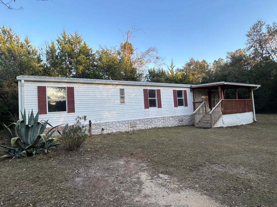 16 x 56 mobile home located in city limits of Ponce de Leon on half acre lot.  Move in ready with all appliances staying.  City water and septic.  8x16 Front porch just right for a couple rocking chairs to enjoy the slower paced living of a small town.  Kitchen has newer appliances including smooth top stove, stainless steel fridge, and dishwasher.  Metal roof and HVAC were replaced a few years ago. Floor covering in kitchen and hallway just replaced.  Bathroom has large garden tub.  8 x16 metal utility shed for storage. Trees along the perimeter add privacy.  Fronts dirt road a block and half from Hwy 90. Would make good starter home, rental or vacation retreat. I-10 short distance away & beaches are South of Ponce de Leon.  Schedule your showing before this one gets away!