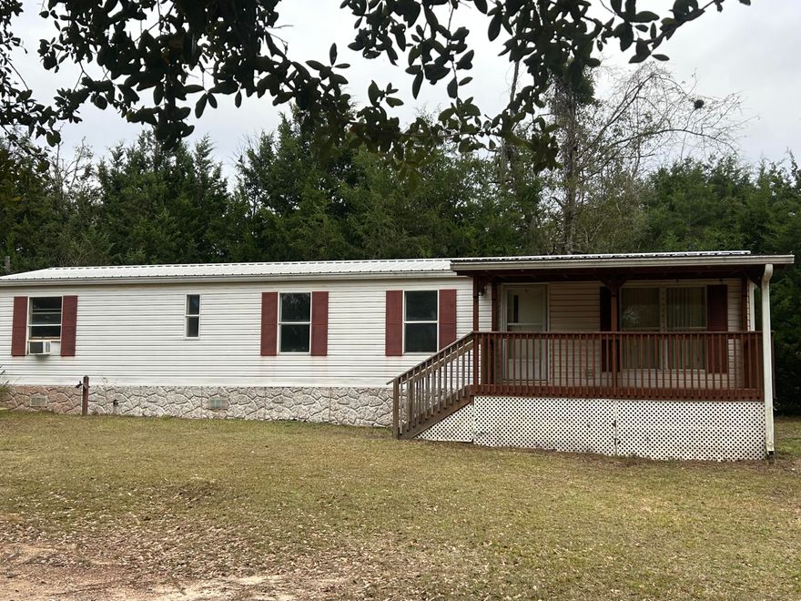 16 x 56 mobile home located in city limits of Ponce de Leon on half acre lot.  Move in ready with all appliances staying.  City water and septic.  8x16 Front porch just right for a couple rocking chairs to enjoy the slower paced living of a small town.  Kitchen has newer appliances including smooth top stove, stainless steel fridge, and dishwasher.  Metal roof and HVAC were replaced a few years ago. Floor covering in kitchen and hallway just replaced.  Bathroom has large garden tub.  8 x16 metal utility shed for storage. Trees along the perimeter add privacy.  Fronts dirt road a block and half from Hwy 90. Would make good starter home, rental or vacation retreat. I-10 short distance away & beaches are South of Ponce de Leon.  Schedule your showing before this one gets away!