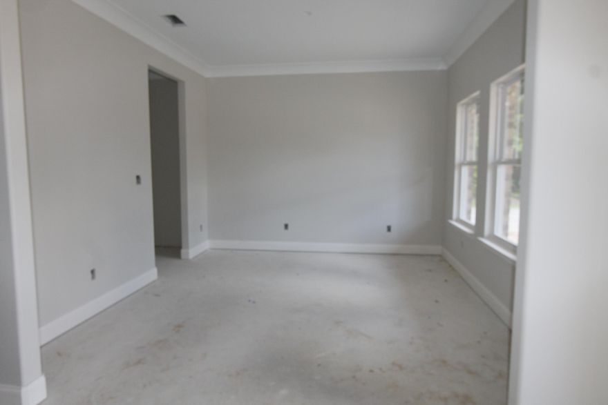 Welcome to Vieux Carre', a premier new 12 lot development featuring Craftsman style homes with a Louisiana flair. Homes will feature slurried brick, hardy board siding, copper lanterns, etc. As you enter the front of this 3/4 home plus office, through the large covered porch with 8 Ft. solid wood stained front door, the dining room is on your left. As you continue down the hallway, there will be rustic wood stained stairwell on the left, and a powder room on the right. Continuing forward, you will then enter the gourmet kitchen which boasts Ivory painted custom cabinetry with crown moulding, 3 CM. granite countertops, Frigidaire Gallery series stainless appliances (including a commercial grade refrigerator/ freezer), and roomy breakfast bar