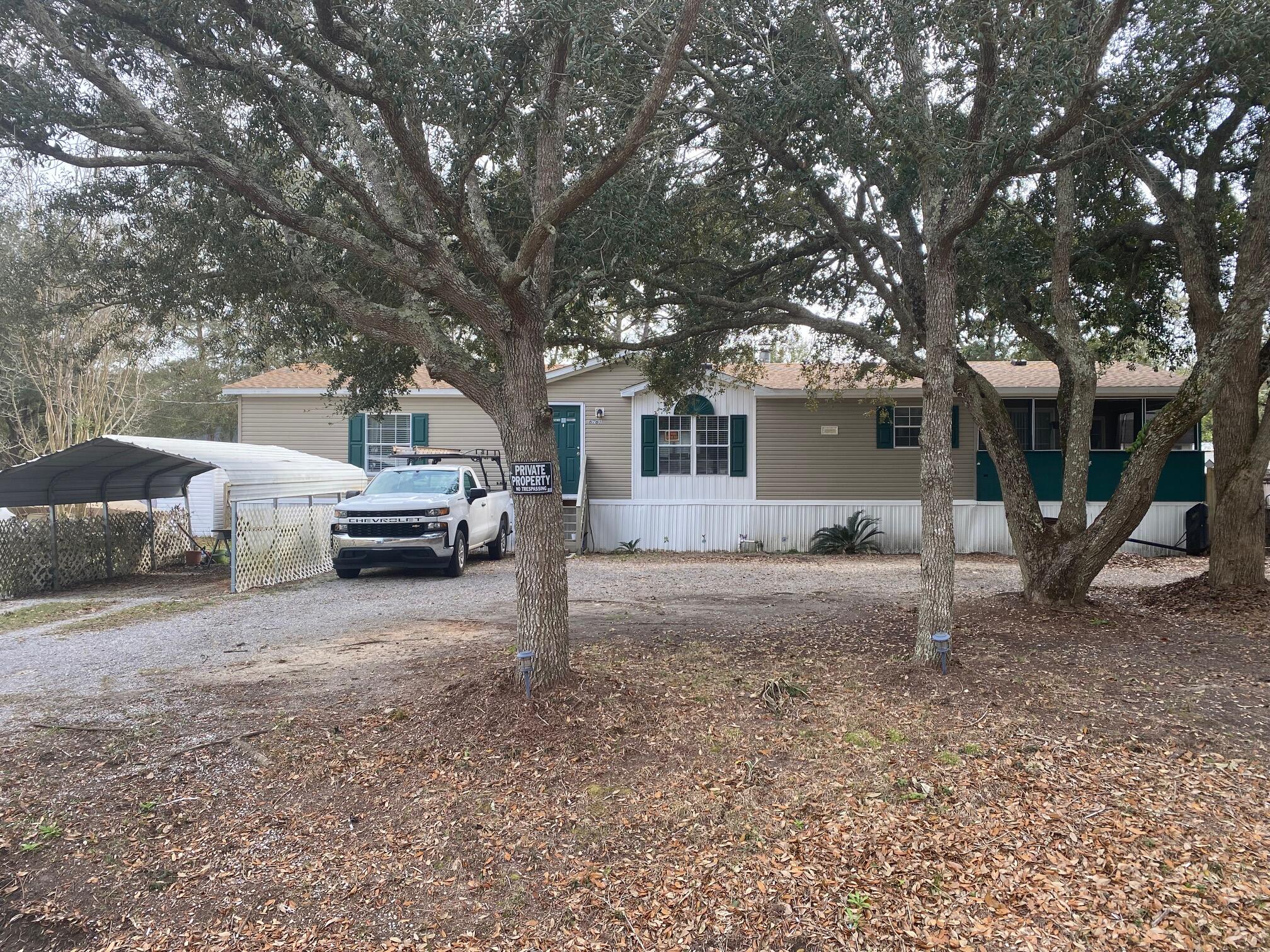 This Spacious 3 Bedroom 2 Bath split floor plan home offers plenty of breathing room. Take a short cut through Holley By the Sea to get to 98 or take 399 to Hwy 87 that leads to the heart of Navarre which lends itself to plenty of restaurants, shopping and more. Only 15 mins. to the BEACH! This home sits on a spacious lot and has a half oval driveway with plenty of parking. RV, BOAT there is room. Carport as well for special care of your vehicle. Backyard has just been cleared to the fence line. New steps in back to laundry room. Roof was replaced in June of 2022, Water Heater in 2021 and AC just serviced and checked out great! Septic tank was pumped and checked in 2019. This home has just has fresh paint throughout and has Vinyl plank throughout common areas and bedrooms