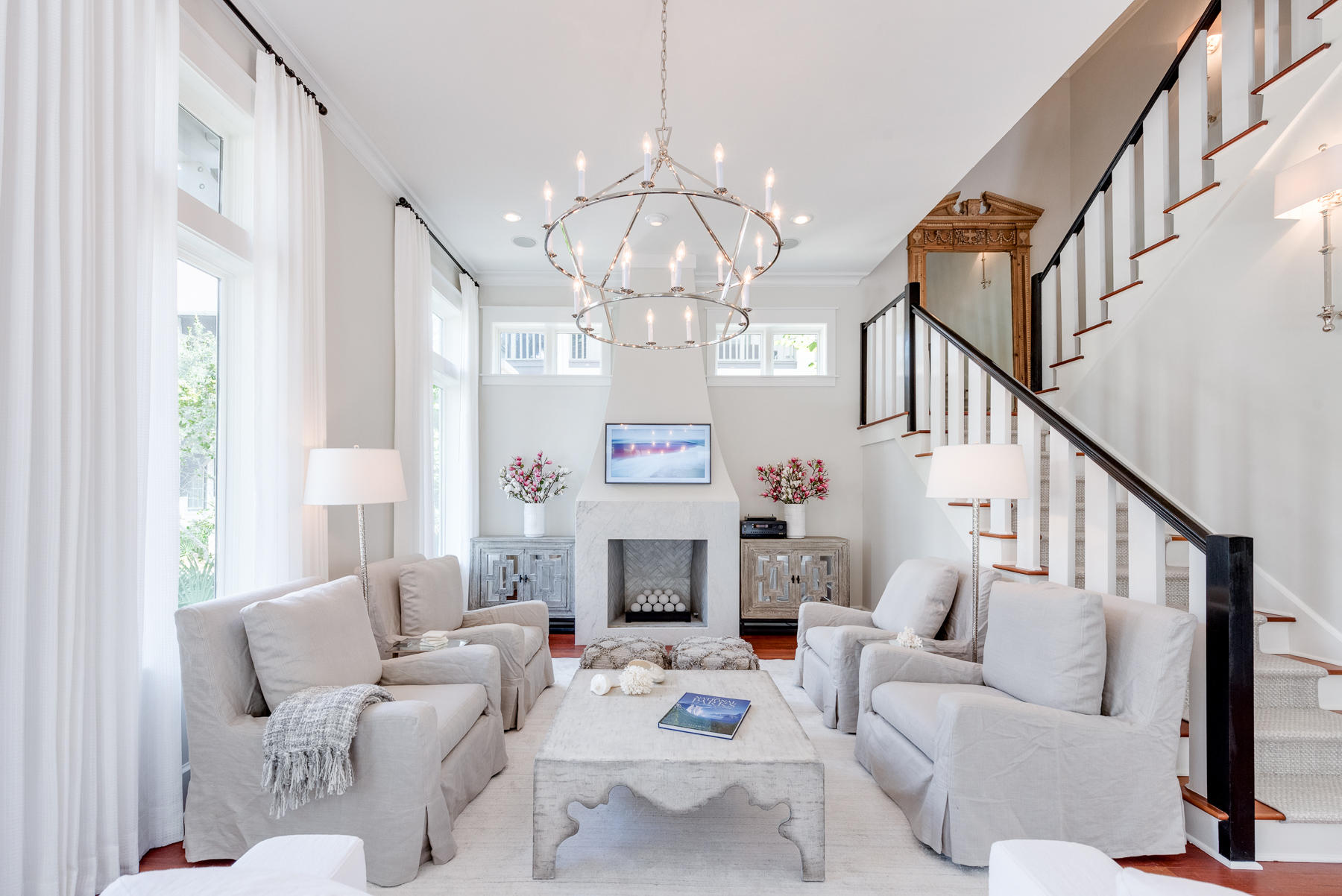 New to market in the heart of Rosemary Beach is this recently updated and elegantly designed coastal luxury! As you step into this home, the gorgeous design and modern decor are sure to wow. A grand light fixture in the living room makes a beautiful centerpiece, and the floor to ceiling fireplace beautifully anchors the room. The interior of the home abounds with stunning updates and luxurious furnishings. Designer lighting throughout compliments the modern coastal decor, and the large chef's kitchen with stainless steel top of the line appliances, and marble countertops, provides a amazing space for the whole family to gather. Dramatic windows flood the home with tons of natural light, and the high ceilings and ample square footage provide for an open and spacious interior.