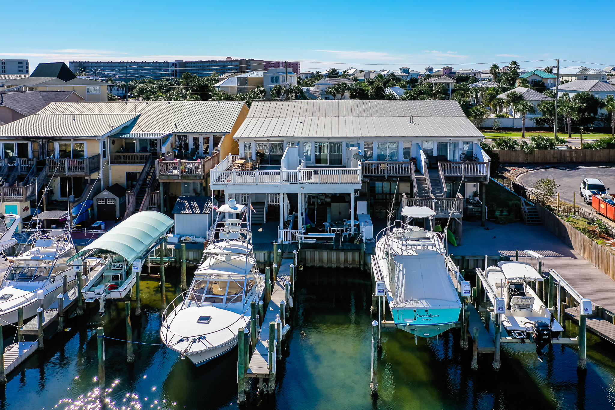 Beautifully updated waterfront townhome on Holiday Isle in Destin. This boater/fisherman paradise comes complete with a upland boat slip capable of supporting up to a 60ft boat with year round deep water and shore power. The unit is a completely renovated 3 bedroom 3 full bath interior end unit with beautiful hardwood floors on the second floor as well as new quartz counter tops in the kitchen, a fully covered lower deck and second level sun deck. This is one of a very few units on the Destin Harbor with the capability to hold up to a 60ft boat and they rarely come on the market