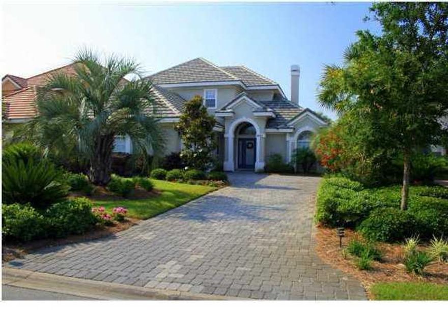 Located on one of the beautiful lakes of Regatta Bay, this beautiful home will welcome you and your family. The spacious living room with its warm hardwood flooring, crown molding, arched doorways, gas fireplace. Sliding glass pocket doors open onto a screened lanai providing gorgeous views of the lake. Kitchen has hardwood floors, wood cabinets, granite counters, tumbled stone back splash. Stainless appliances and a separate water filter. Breakfast nook and dining room overlook the lake. The master suite with treyed ceiling is located on the lower level. Master bath has sunken tub complete with spa jets, separate ice block shower and tile floors. Master suite adjoins the screened lanai. Upstairs is a spacious media room complete with surround sound,