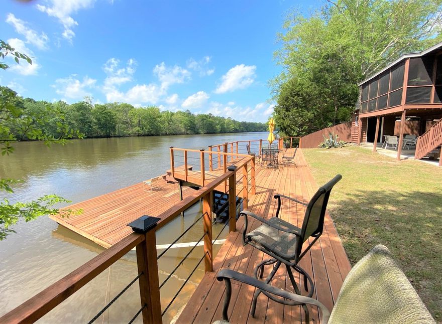Great opportunity to own this river front home located off Hwy 20 in the Bruce area of S Walton County (between Ebro & Freeport).  Main part of home (upper level) is 1440 SF with 1 BR, 1 bath. This home has a wide open floor plan with a large living room & kitchen/dining combo.  Hardwood floors, granite counter tops & breakfast bar in kitchen. Guest suite is on ground level, with 1 BR, 1 bath (612 SF). Covered porch (partially screened) spans the entire back of home, overlooking the river. There is also a screened porch area & covered patio on ground level, as well as a deck spanning across most of the river frontage, with stairs going down to the floating dock at the river. Call and make an appointment to see this beauty today. Please don't go onto property unaccompanied by an agent.