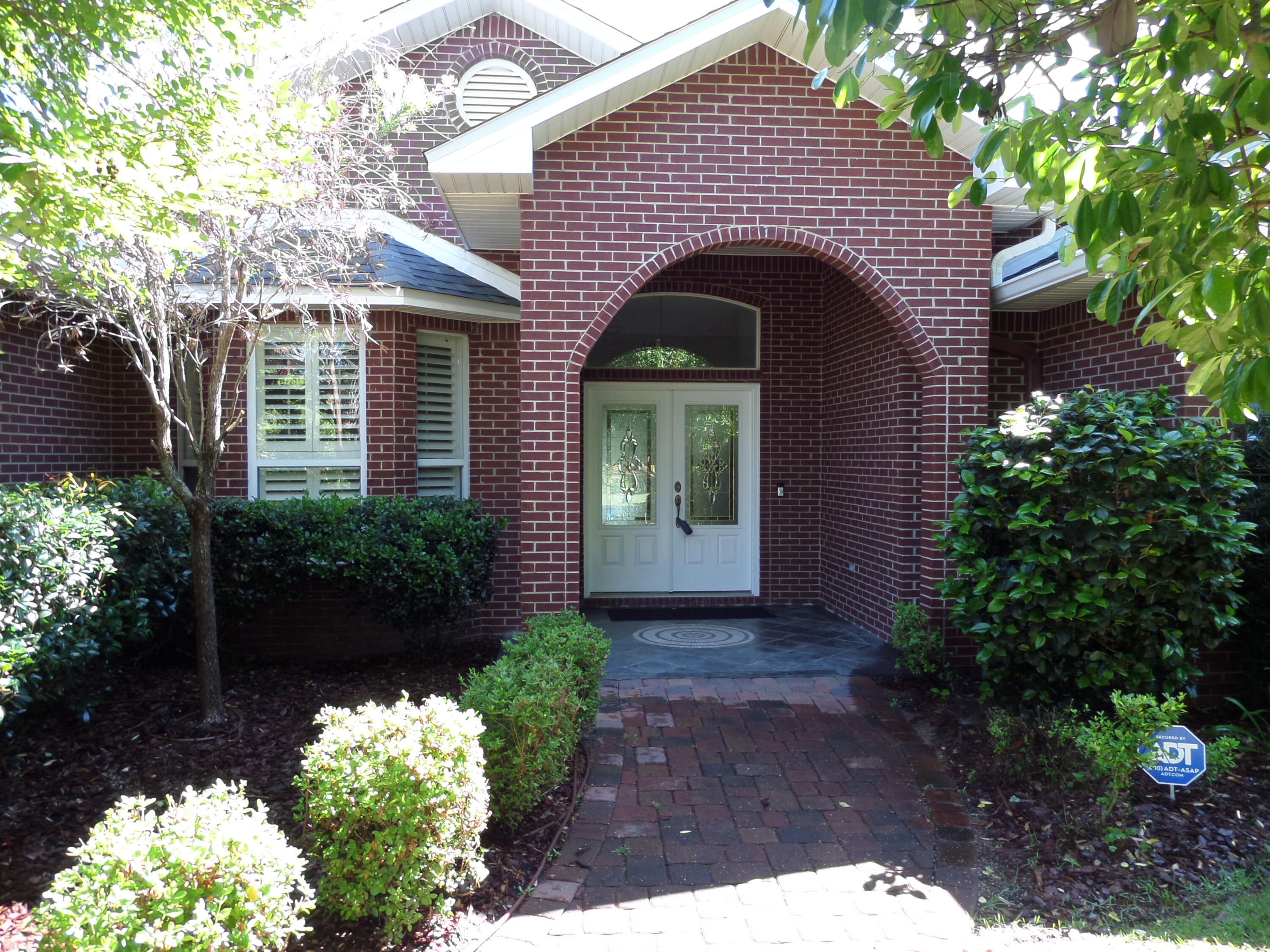 Custom Design Brick Ranch that backs up to the Bluewater Bay (BWB) Golf Course in BWB subdivision. Open floor plan with multiple doors leading to a large, covered patio, ideal for entertaining with an outdoor granite wet bar. Lushly landscaped with a wrought iron fence. Lanai with a large inground heated saltwater pool with spa. 4 Bedrooms 3 Baths, large master suite. A new Roof installed in 2025. Home upgraded with many extras. Formal living/dining room combination with crown molding throughout. Kitchen and baths have granite counters. Porcelain tile throughout the home. Fireplace in Family room, Cental Security/Sound system. A highly sought after neighborhood in BWB. See documents for additional information.