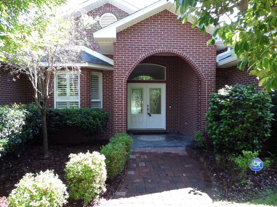 Custom Design Brick Ranch that backs up to the Bluewater Bay (BWB) Golf Course in BWB subdivision.  Open floor plan with multiple doors leading to a large, covered patio, ideal for entertaining with an outdoor granite wet bar. Lushly landscaped with a wrought iron fence.  Lanai with a large inground heated saltwater pool with spa. 4 Bedrooms 3 Baths, large master suite. A new Roof installed in 2025. Home upgraded with many extras.  Formal living/dining room combination with crown molding throughout. Kitchen and baths have granite counters.  Porcelain tile throughout the home. Fireplace in Family room, Cental Security/Sound system.  A highly sought after neighborhood in BWB.  See documents for additional information.