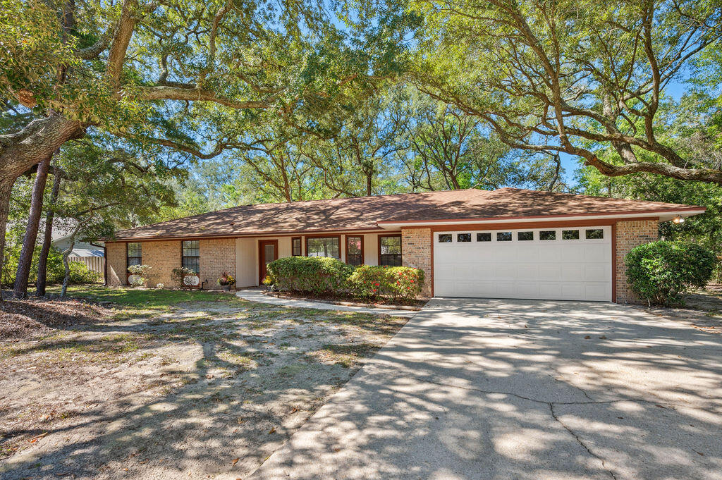 This Bluewater Bay home has the most wonderful layout with 2 living rooms and a fireplace! The kitchen has real wood cabinetry, smooth top stove, and stainless steel fridge. The home enjoys easy to clean tile flooring throught the living areas and carpet in the bedrooms. There are2 spacious bedrooms that have easy access to the hall bathroom. The hall bath has a tub and tile surround, toilet and vanity. The master bedroom is ample sized, with its own ensuite bathroom with tiled shower.Not only does this home have a screened-in porch which is perfect for summer days, you will also enjoy the large (almost .40 acre) lot!