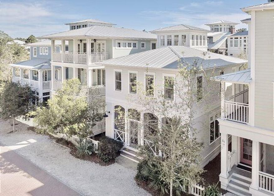 Experience the epitome of coastal living in this exceptionally decorated three bedroom plus sleeping loft cottage, designed for ultimate comfort and style. Featuring gleaming hardwood floors throughout, the open-concept first level offers a cozy fireplace, half bath, and a stunning kitchen. The alluring tiled wall with open shelving is the focal point in the kitchen. A center island offers extra storage and accommodates additional seating for extended family. The white-washed wood dining table seats eight. Induction cooktop and KitchenAid appliances complete the kitchen. Upstairs, enjoy a luxurious master king suite with a spa-like bath and dual vanities, a second king bedroom and a fun bunk room with two sets of bunks share a full hall bath. The third level tower loft provides additional sleeping space with town views. This home features an 8'x19' covered front porch with storage closets, and on-site parking at your back door. Steps from the beach and town square, this property is ideally located near all community amenities, including pools, tennis courts, pickleball, and a fitness center. 