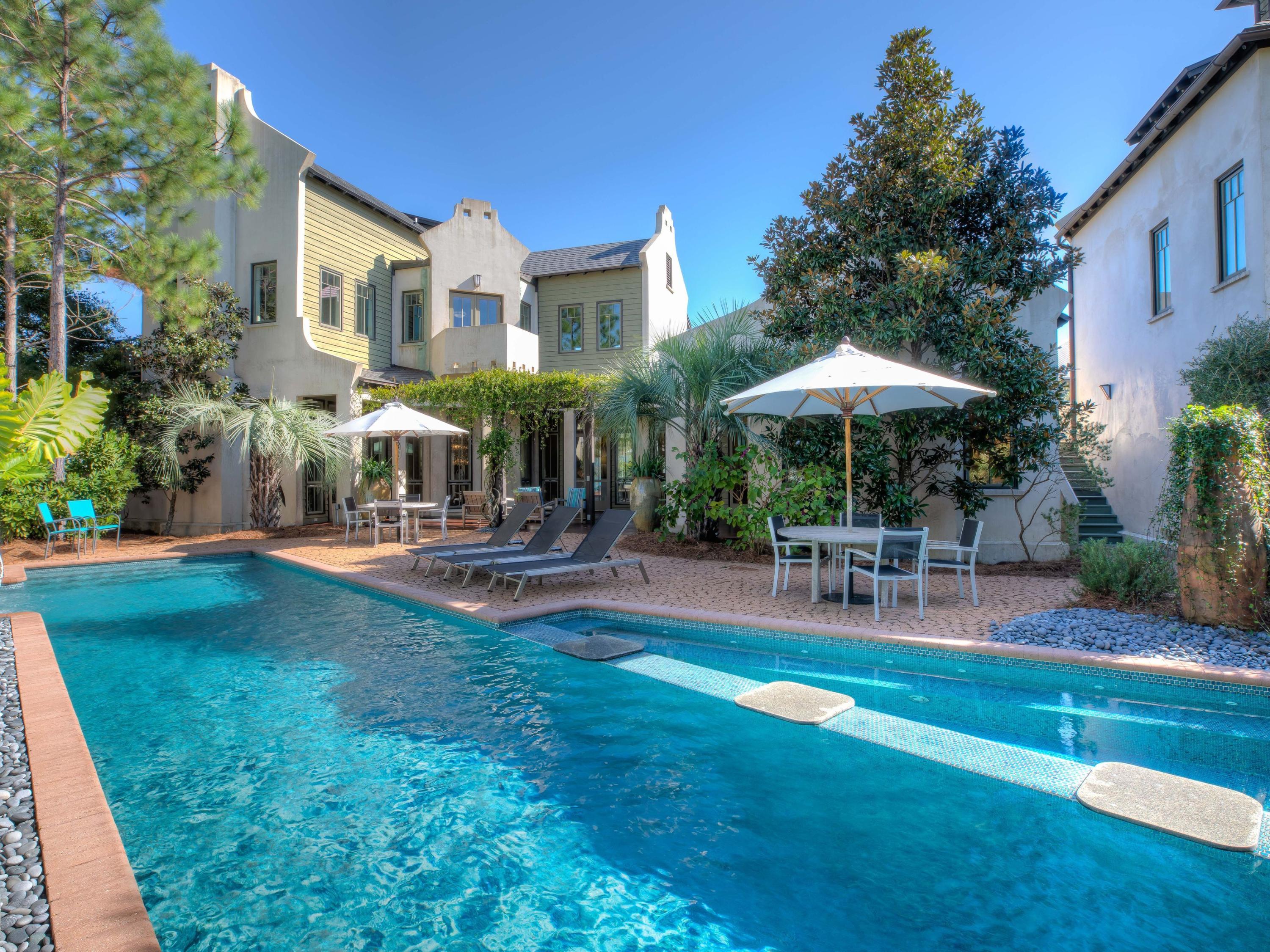 From the copper roofing and tree tops to the bottom of the saltwater pool, this property evokes the elegance and luxury of a five-diamond resort. A grand main house and stellar three-story carriage house over the garage comprise this private estate that offers a graceful, incomparable lifestyle. Entertaining is a sensational event throughout the house and around the hot tub, waterfall and linear fire pit. Myriad outdoor spaces invite solitude, like the hammock, cozy conversations on private balconies and pleasant socializing among family and guests in an exclusive, private oasis. This unique compound offers the savvy buyer the majesty and quality of a palace flawlessly blended with the magical allure of a super fun beach property in a class by itself.