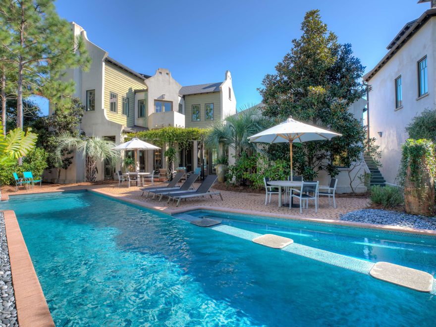 From the copper roofing and tree tops to the bottom of the saltwater pool, this property evokes the elegance and luxury of a five-diamond resort. A grand main house and stellar three-story carriage house over the garage comprise this private estate that offers a graceful, incomparable lifestyle. Entertaining is a sensational event throughout the house and around the hot tub, waterfall and linear fire pit. Myriad outdoor spaces invite solitude, like the hammock, cozy conversations on private balconies and pleasant socializing among family and guests in an exclusive, private oasis. This unique compound offers the savvy buyer the majesty and quality of a palace flawlessly blended with the magical allure of a super fun beach property in a class by itself.