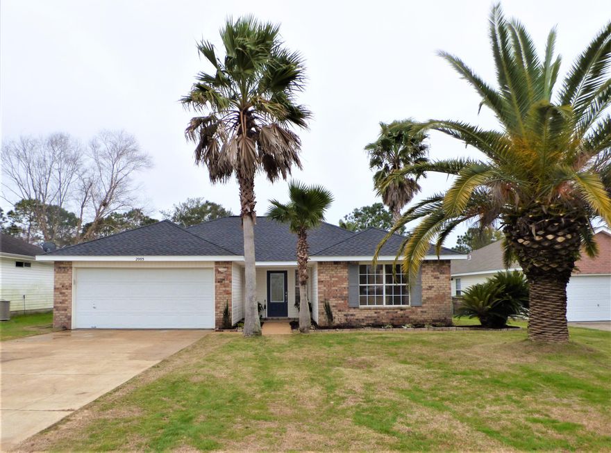 This UPDATED AAA home is Affordable, Adorable, Available for a quick close and is perfectly located in Shadow Lakes Subdivision that boasts sidewalks, streetlights, underground utilities, spring fed lakes, and playground/park.   This move-in ready, low-maintenance brick/vinyl siding, 3 bedroom/2 bath home offers great curb appeal and lives larger than the square footage indicates with a spacious living room with cathedral ceiling, kitchen/dining room, a split floor plan, a laundry room, 2 car garage, a large covered back porch, and beautiful mature palms. MAJOR UPDATES include new roof, new LVP flooring, new kitchen cabinets, new granite counter tops, new light fixtures/ceiling fans, new master bathroom vanity with vessel sinks, new tiled master bath shower with glass door, new guest bath