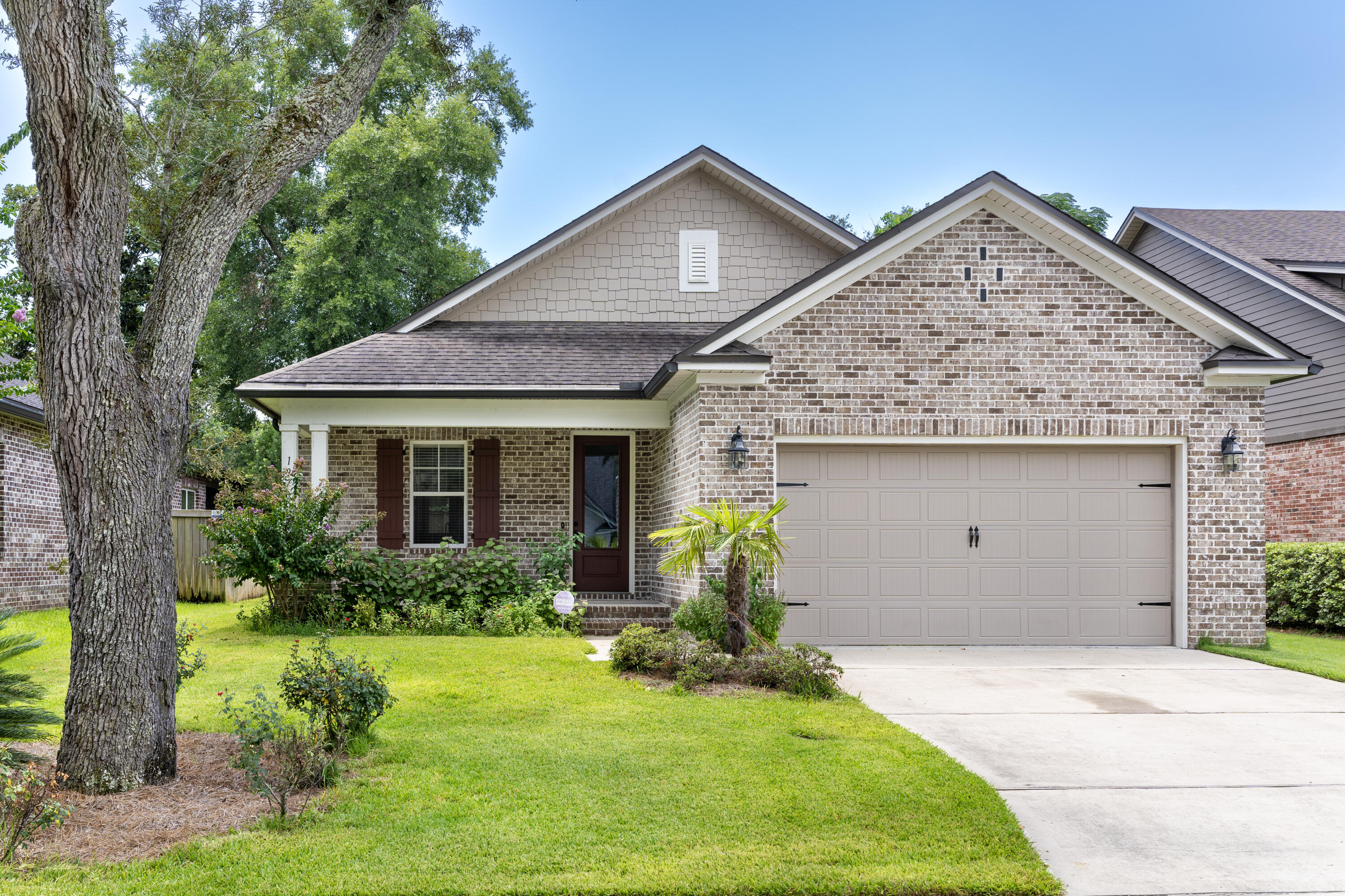 Florida Coastal Craftsman Design home built by Randy Wise Homes located in the private community of Hattie's Grove in central Niceville. This open concept home features 4 bedrooms and 2.5 bathrooms. The kitchen is the heart of this home offering a large center island, stainless appliances and an abundance of cabinets and counter space. The home is easy maintenance with wood laminate flooring in the living areas, tile in the bathrooms and laundry and carpet in the bedrooms. The large master suite features a bath with a soaking tub, separate shower, walk-in closet and double vanities. This home was the model home and it still shows like a model home.  Make it yours today! Noteworthy features include HVAC (2020), plantation blinds, hurricane shutters, sprinkler system and alarm system.