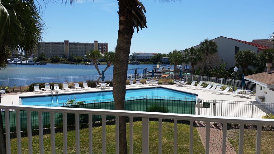 FULLY FURNISHED! RENTAL READY! MUST SELL! The MOST desired building in Dolphin Point. See the views and you'll know why. This 2 bedroom, 2 bath, end unit condo in Building C, features stunning views the moment you walk in. Kitchen features granite counter tops, under cabinet, LED A/C lighting and smooth top stove. Master bedroom offers water views. 2nd bedroom has a murphy bed. New in the past 2 years: HVAC inside & out, w/WiFi Smartphone thermostat, water heater, disposal, ceiling fans, fresh paint. Full sized washer/dryer stack unit, (hard to come by in Dolphin Point,) An assigned storage unit conveys. This end unit affords gorgeous sunset views and fireworks from the Harbor. Enjoy the sandy beach, in ground pool, tennis, docks, and more, plus deeded beach access! Call & Tour Today