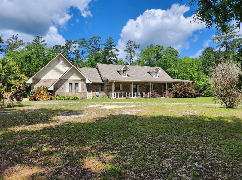 Looking for a place to call HOME?? Such a great location and room to have a garden or your pets. Borders on Crooked Creek.This is a beautiful home with loads of charm. County Style complete with wrap around porches and a rear open deck. Living room is spacious and features built in book cases and a full brick fireplace. Immaculate!! This kitchen is full of cabinets and a nice pull up bar for cozy morning conversations and coffee time. Do not wait too long to see this ONE!! On 3 plus groomed acres with a great outdoor shop and covered work space, and if you like to fish, then you will have your very own fish cleaning station and sink. Double car garage to keep your vehicles clean and ready to roll..