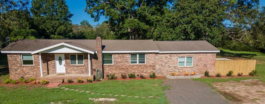 Don't let the Jay address fool you. Only 20 minutes from Milton/Pace. Nicely landscaped and sitting on 2 acres with about 100 feet of uncleared space in the back.  When you walk in there is an open living area that leads to the custom-designed kitchen. The kitchen has slide-out drawers in two cabinets for pantry storage. Three bedrooms are on the left side of the house with one full bathroom. Just past the kitchen is a large dining room that has a built-in counter that can be used as a breakfast bar. The half bath is located in the laundry room right off of the dining room. There is a step down from the dining room that leads to the master bedroom or the backyard. The master is a finished converted garage with a full bath and sliding doors to the outside. Schedule your showing today!