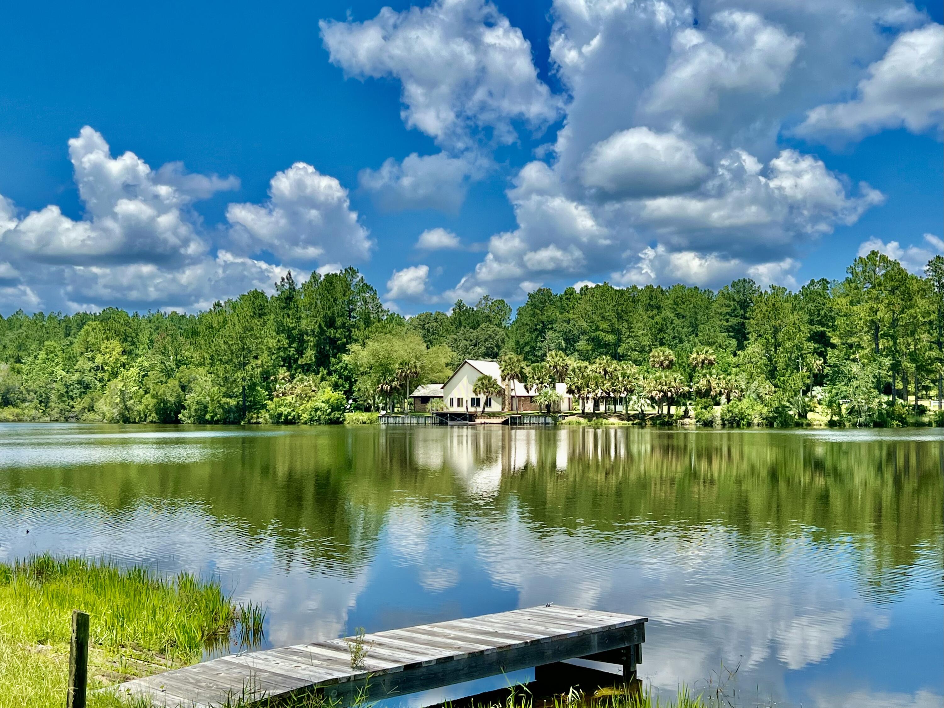 MULTIPLE OFFERS - Seller requests that all HIGHEST AND BEST OFFERS to be submitted to listing agent no later than 2 PM on 7/22/22. Stunning WATERFRONT Property!! Boasting a 90' x 24' pole barn and complete w/ power, septic and private well, this property is ready for you and your house plans. Imagine your mornings waking up to a beautiful sunrise over this amazing spring fed lake. A small dock and boat launch are located at water's edge. The property has numerous palm trees as it was previously part of a nursery and also comes with several Conex containers and an outbuilding adjacent to the pole barn. The property is gated and there are cameras on the property. Appointment required for viewing. Schedule your viewing of this fantastic property TODAY!