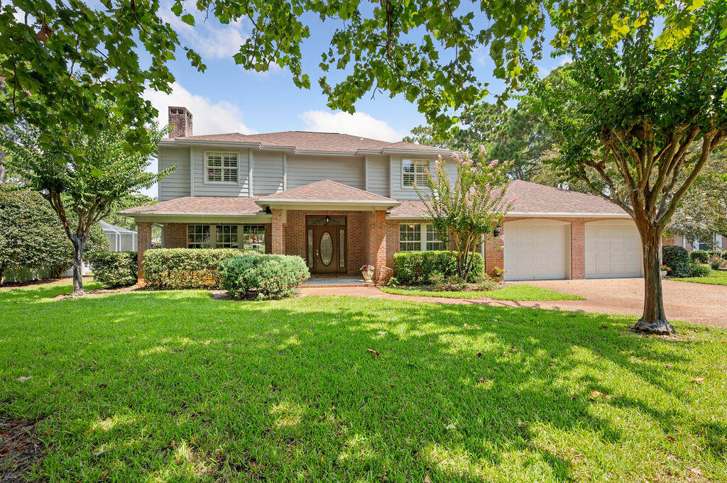 Nestled in the highly sought-after Southwind subdivision, this beautiful four-bedroom, three-bath home offers an unparalleled living experience. Situated on hole #1 of the Marsh golf course, this property boasts breathtaking views that can be enjoyed from multiple vantage points. The elegant design and spacious layout make this home perfect for both entertaining and comfortable family living. Spacious Living room to the left upon entry with hardwood flooring and a gas fireplace. Formal dining off of the living room overlooking the backyard! Kitchen right off the dining room boasting granite countertops, white cabinets, stainless appliances and plenty of cabinet space. Cozy kitchen nook with lots of natural light and lovely golf course views. Off of the kitchen is the family room overlooking the lovely backyard and golf course. There is a back patio right off of the kitchen and family room. One bedroom is conveniently located downstairs in front of home with access to its own bathroom. This room could also be used as an office. Split bedroom floor plan upstairs with Master on one side and 2 additional bedrooms on the other with a shared bathroom in between. Master suite is spacious with sliding glass doors leading to a balcony overlooking the backyard and golf course. Master bath with oversized garden tub, separate shower and dual vanities. Entire home has just been freshly painted inside and out, new fixtures, new blinds, new ceiling fans, and new lighting. Roof is 2019! With top-notch amenities and a prime location, this home is a true gem in the heart of Southwind. Call for your appointment today to view this beautiful home!!!