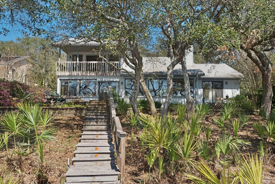 PRICE REDUCTION - Come home to this breathtaking panoramic view of the water from the moment you open your front door. Tranquil cul-de-sac home in private waterfront community, North Lake Pippin, featuring no HOA. Almost 100' of fresh water lake frontage on Lake Pippin with quick access to the Bay and Gulf. The property sits on the Northwest side of Lake Pippin. Seawall and deep water dock with room for multiple boats. The pass is open and it is dredged by the county.Waterfront views from the back of the house faces South featuring terraced decks and gardens adjoining enclosed sun porch. This home features dramatic ceilings with tongue and groove ceilings and expansive windows highlighting the views. The home is also hard wired for a generator.