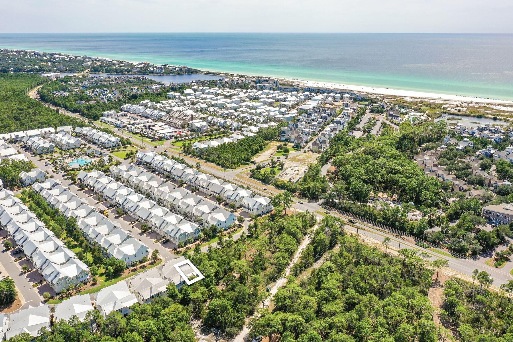 Completely surrounded by lush preserved land, this highly desirable A unit in the neighborhood of Prominence offers the best combination of privacy and convenience with a newly replaced HVAC. Bordering wooded areas yet near the front of the neighborhood, this A unit offers close proximity to neighborhood amenities, the shops and local restaurants of The Big Chill and the bike path running along Scenic Highway 30A. With immense natural light, the living and dining areas provide ample space to entertain or relax with family and friends after a long day at the beach. The bright coastal decor offers a fresh and inviting retreat. The kitchen is designed with the modern chef in mind with a gas range, gleaming stainless steel appliances, pristine granite countertops and a large center island with a breakfast bar.art Beyond the living area, double doors lead to the rear porch perfect for alfresco dining or morning coffee with tree-lined views. The first level is also nicely appointed with a powder bathroom, dedicated laundry room and spacious owner's closet. A staircase leads to the second level where the master suite along with two guest bedrooms and a shared full bathroom can be found. The master suite offers large windows overlooking the preserved land with ample natural light flowing through and a large bathroom with a walk-in shower, double vanity and spacious walk-in closet. The two spacious guest suites offer wooded views and access across the hallway to a full guest bathroom. The location of this home is perfectly suited as both a rental investment and second home. The private two-car attached garage is an added convenience for those wanting to store the included six-seater golf cart, bicycles and beach toys or personal vehicles. Prominence offers many community amenities including a large lagoon-style pool, grilling areas and a fitness room. The Big Chill is located in the heart of Prominence hosting an array of community events, football game viewing, concerts, shopping and popular local eateries.