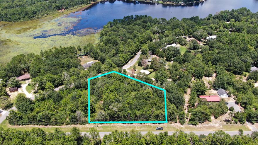 Beautiful 1 acre lot - beautiful location! Just outside the city limits of DeFuniak Springs on a paved road, this mostly level lot would make a perfect homesite. It would be possible to have a water view of Lake Juniper. Some large, mature oaks and magnolias are scattered throughout.