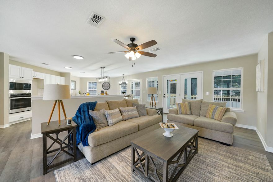 Come see this stunning 3BR/2BA home nestled on a nearly 1/2 acre corner lot in highly coveted Golf Course Estates! Boasting modern finishes throughout, this home has been upgraded with floor to ceiling paint, updated kitchen and baths, LVP flooring, and new lighting, just to name a few! With 1976SF, this beautiful home offers an abundance of room for your family, friends, and guests. With a split floor plan and open concept, this home lives BIG! You will enjoy evenings sitting on your 276 SF screened-in patio, or grilling on the new deck surrounded by mature trees. The trees extend along the back and one side of the property, offering extended privacy and a barrier to noise.